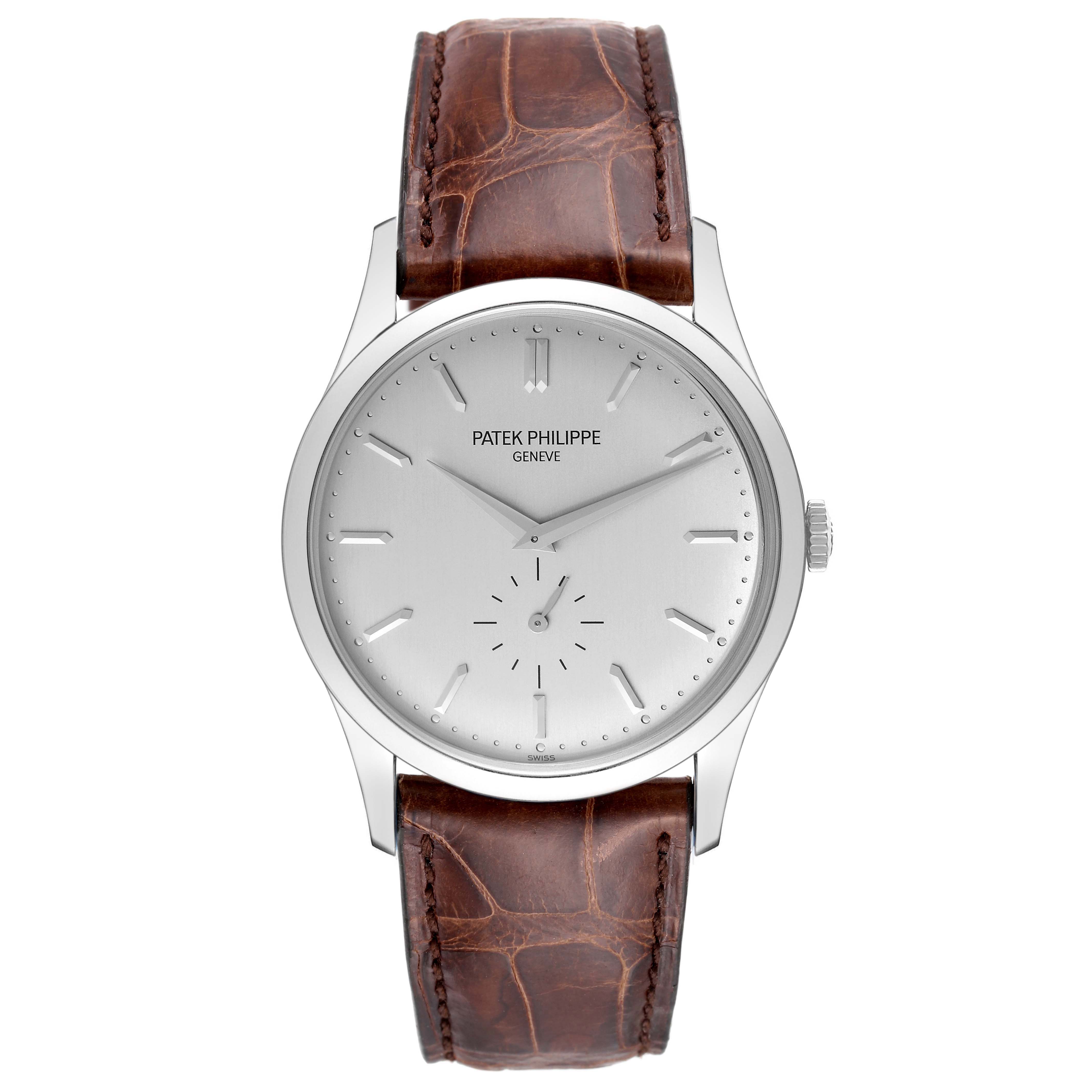 The image shows a front view of a Patek Philippe Calatrava 5196G Men
s White Gold Silver Dial 5196G Men
s White Gold Silver Dial watch with a brown leather strap and a silver dial.