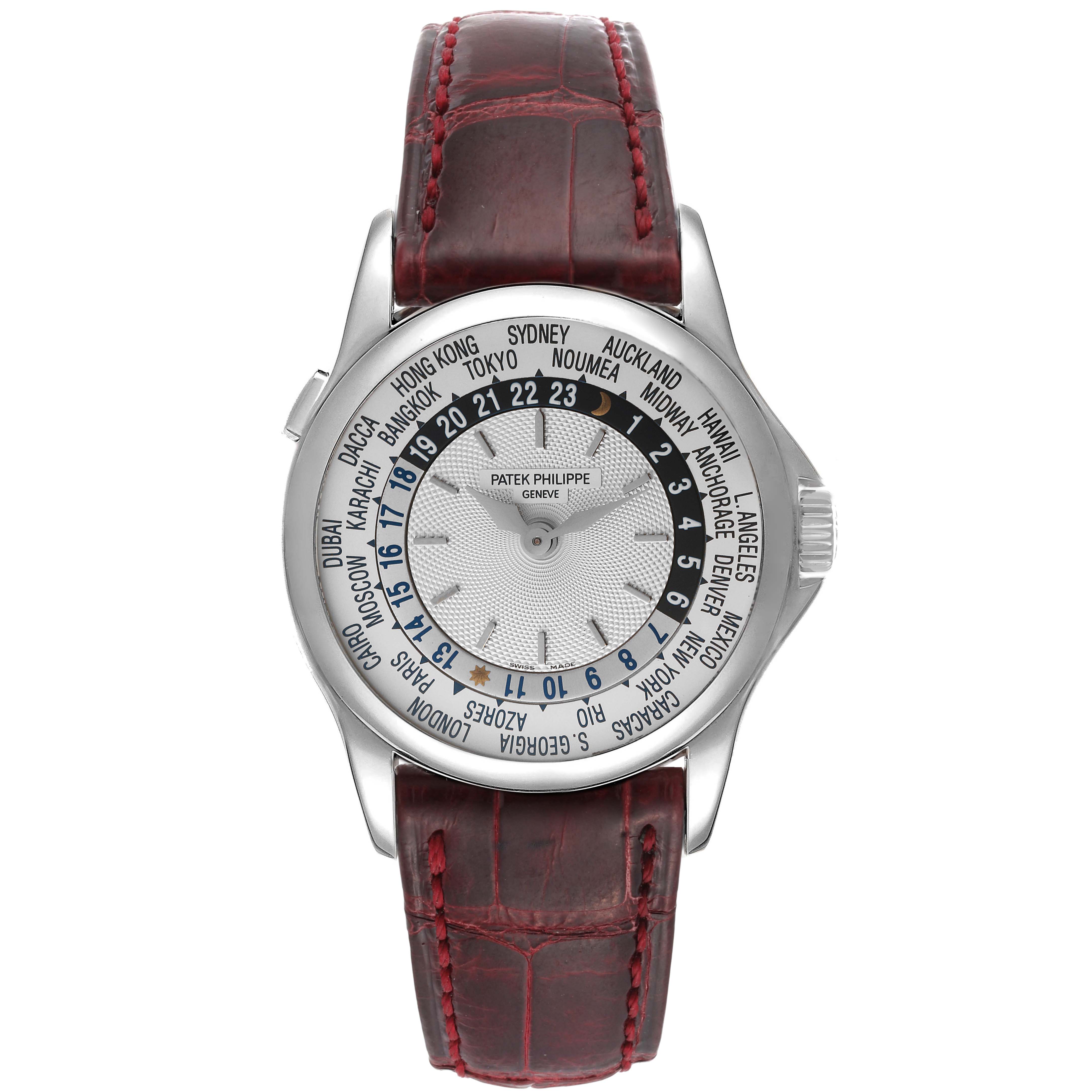 This image shows the face and strap of a Patek Philippe Complications 5110G Men's White Gold Silver Dial 5110G Men's White Gold Silver Dial model, featuring world time zones and a leather strap.