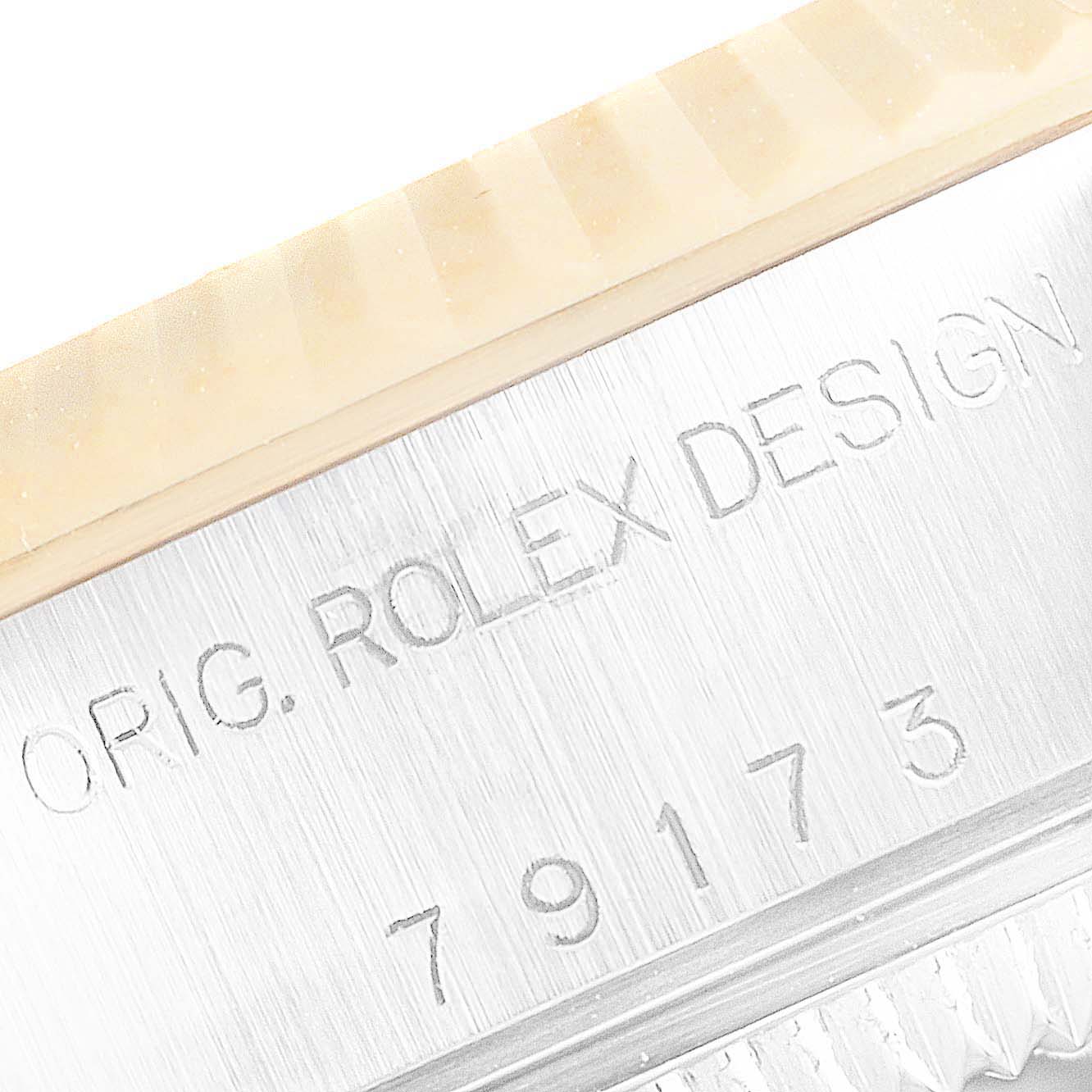 The image shows a close-up angle of the serial and model number engraving on the side of a Rolex Datejust 79173 Women's Steel and Gold (two tone) White Dial 79173 Women's Steel and Gold (two tone) White Dial.