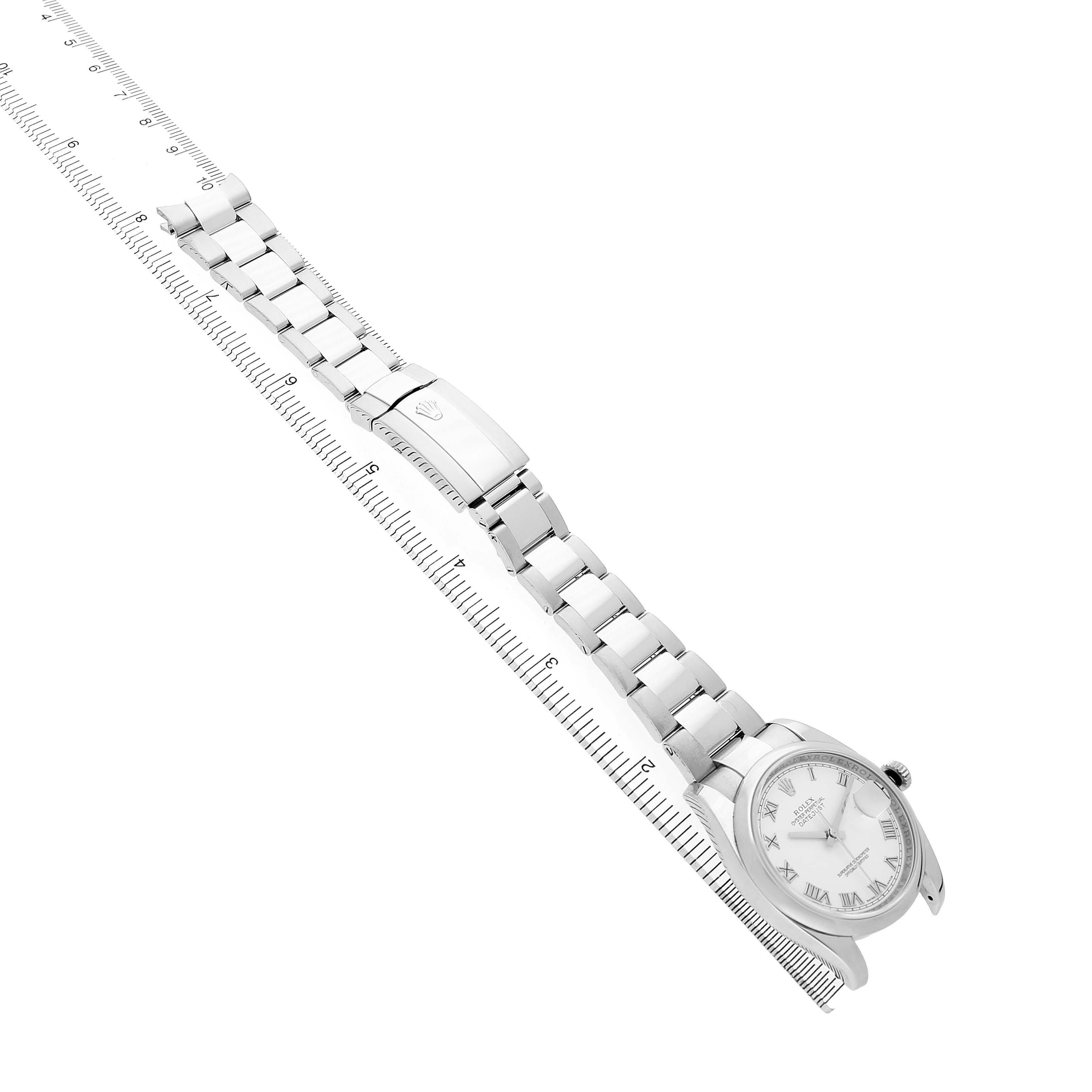 The Rolex Datejust 116200 Men's Stainless Steel White Dial watch is shown in a side angle, displaying the bracelet and clasp alongside a ruler for scale.