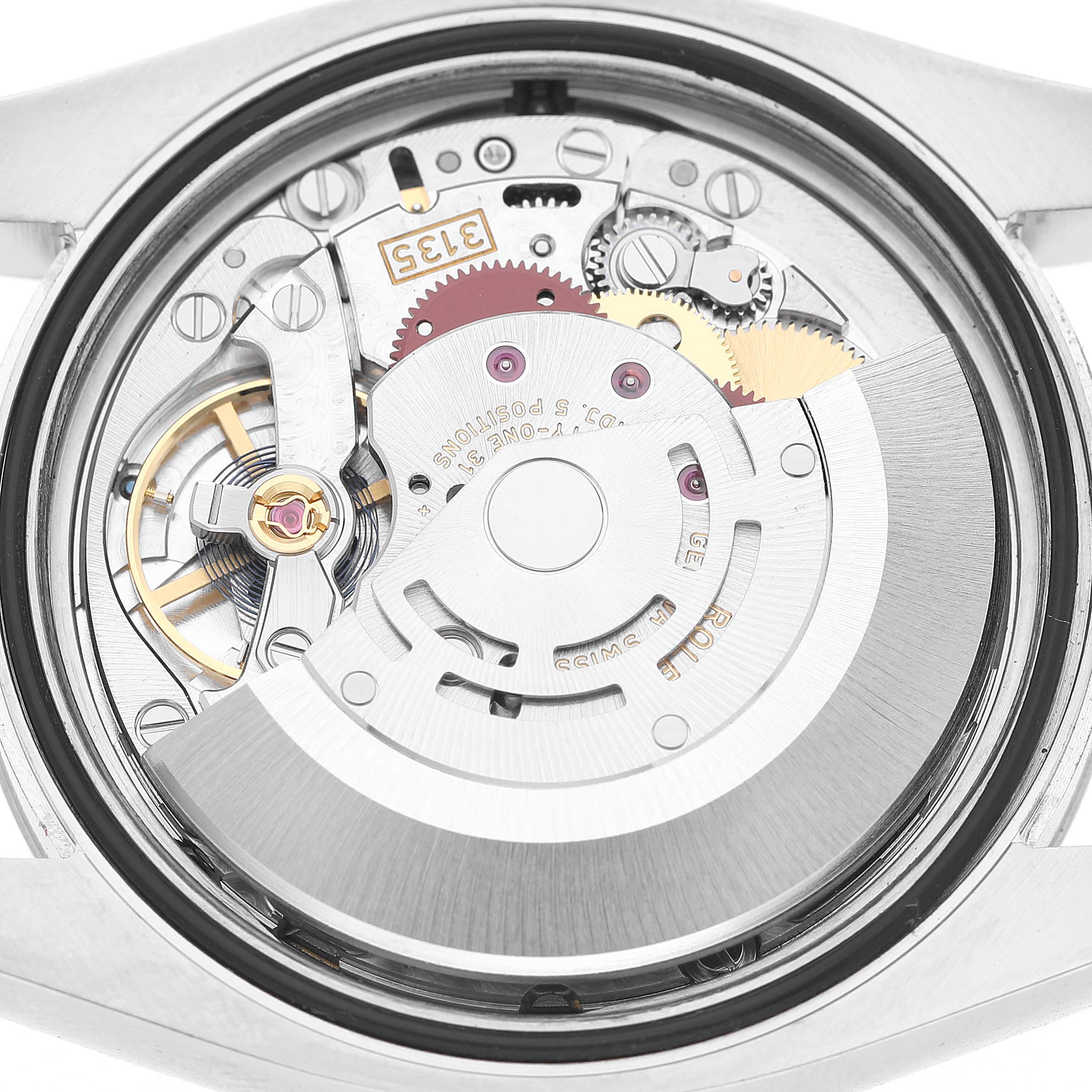 The image shows the back view of a Rolex Datejust 116200 Men's Stainless Steel White Dial, highlighting its exposed movement and inner components.