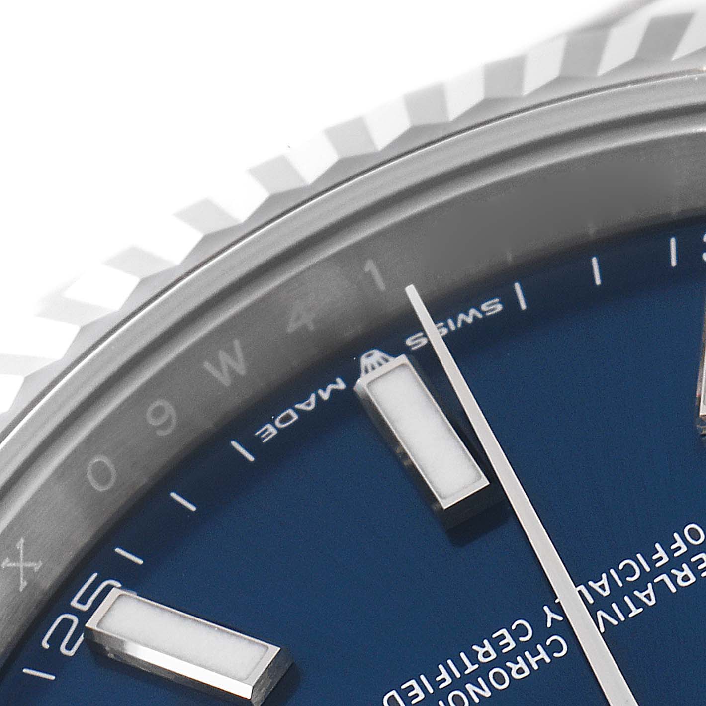 The image shows a close-up of the Rolex Datejust 41 126334 Men
s Stainless Steel Blue Dial 126334 Men
s Stainless Steel Blue Dial watch, focusing on parts of the bezel, dial, and hour markers.