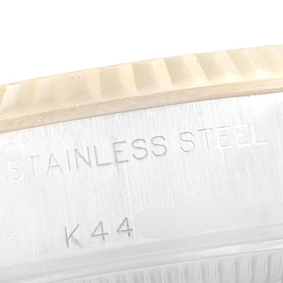 This image shows a close-up of the side of a Rolex Datejust 79173 Women's Steel and Gold (two tone) Blue Dial 79173 Women's Steel and Gold (two tone) Blue Dial watch, focusing on the stainless steel case with partial engravings visible.