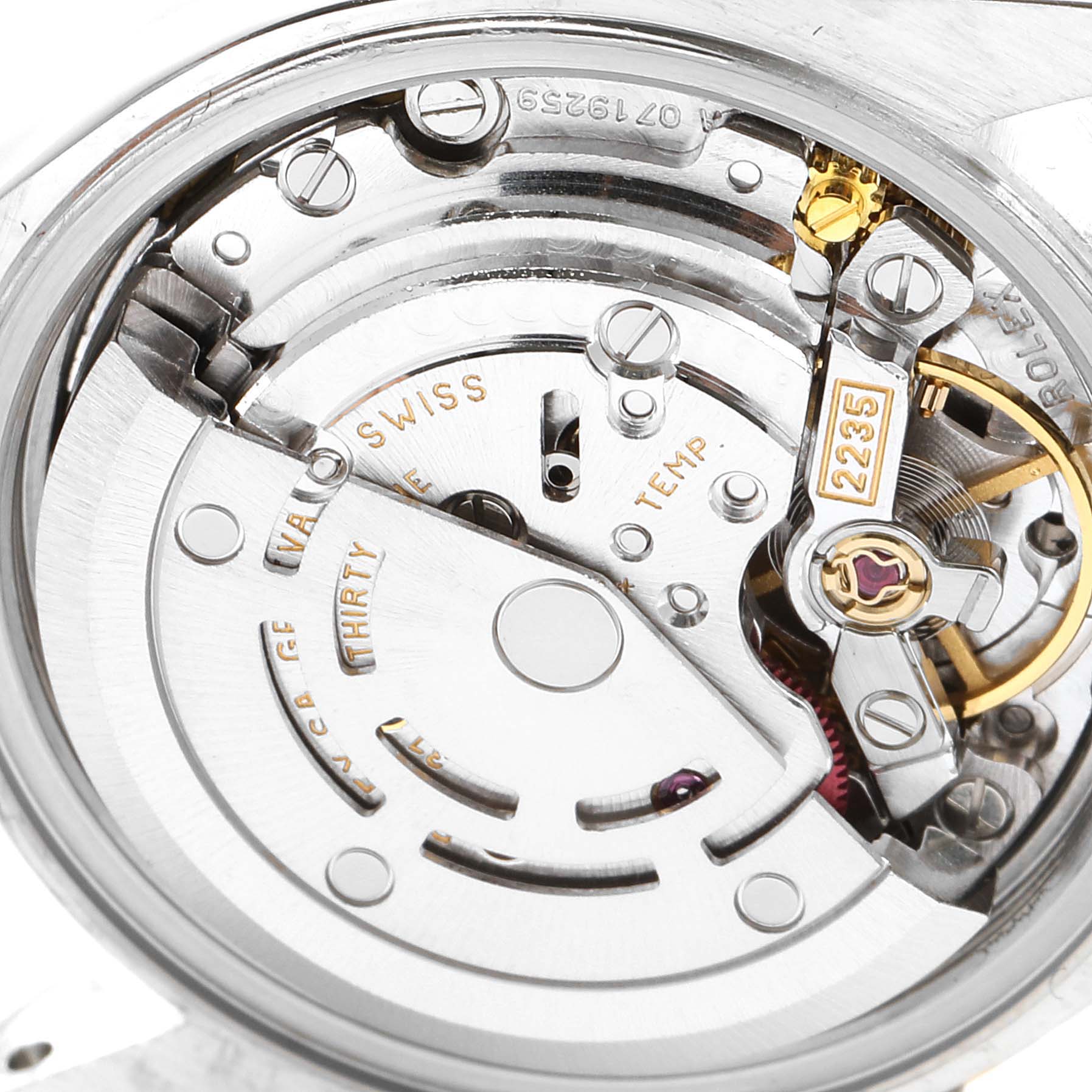 This is a close-up view of the Rolex Datejust 79173 Women's Steel and Gold (two tone) Blue Dial 79173 Women's Steel and Gold (two tone) Blue Dial watch's movement, displaying various internal components and engravings.