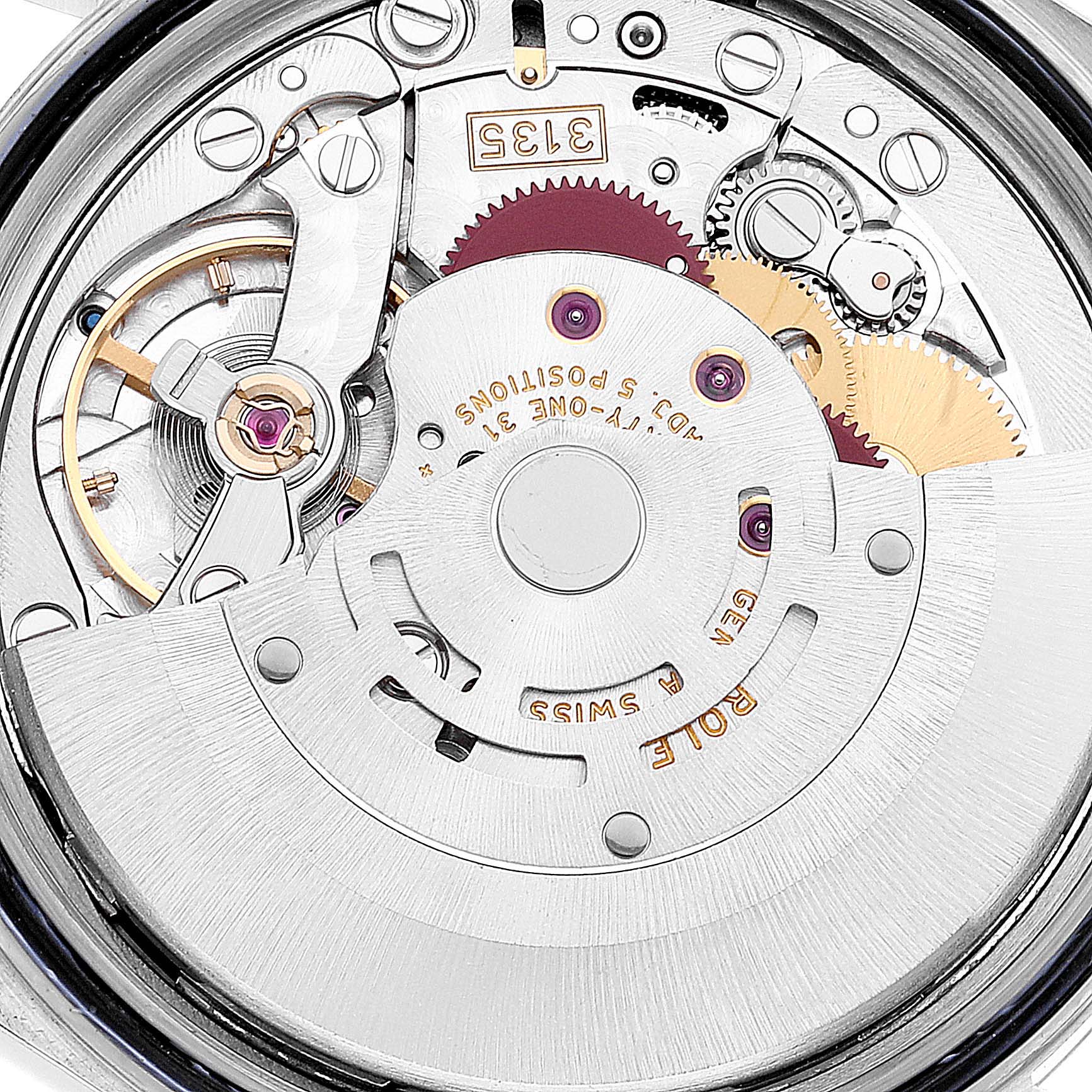 The image shows a close-up of the Datejust model by Rolex's mechanical movement with visible gears and components.