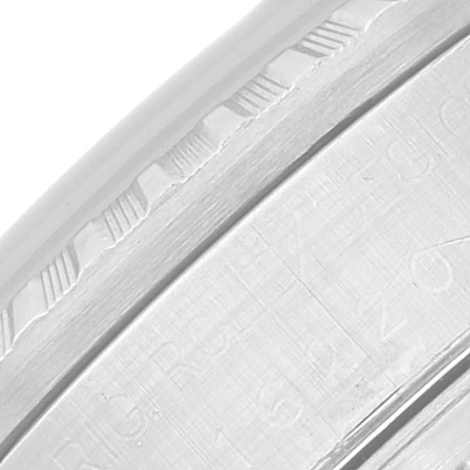 This close-up image shows a partial view of the bezel and the edge of the dial of a Rolex Datejust 16220 Men's Stainless Steel Black Dial 16220 Men's Stainless Steel Black Dial watch.