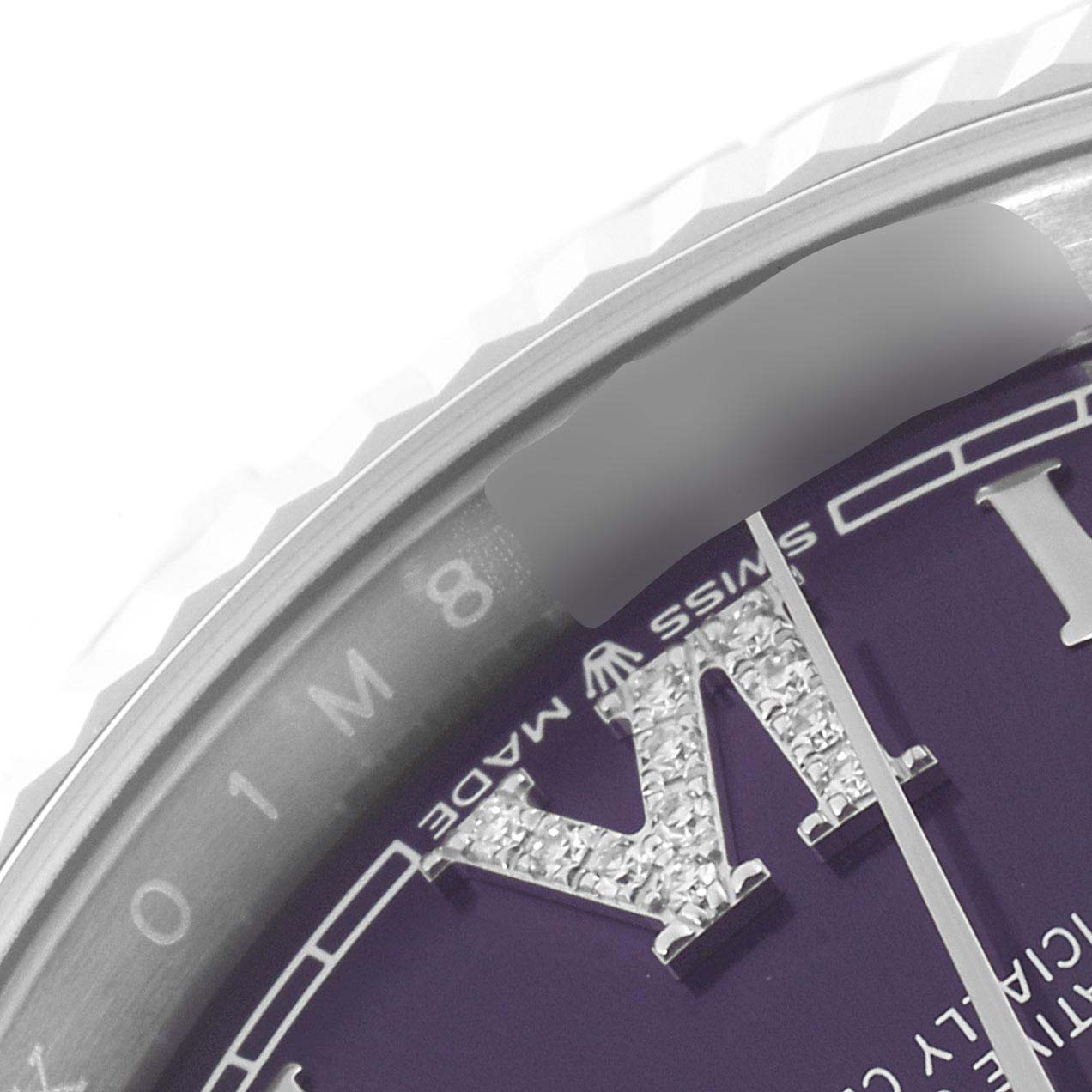 This close-up of a Rolex Datejust 126234 Men's Stainless Steel Purple Dial 126234 Men's Stainless Steel Purple Dial watch shows part of the dial, the "VI" numeral, and the fluted bezel.