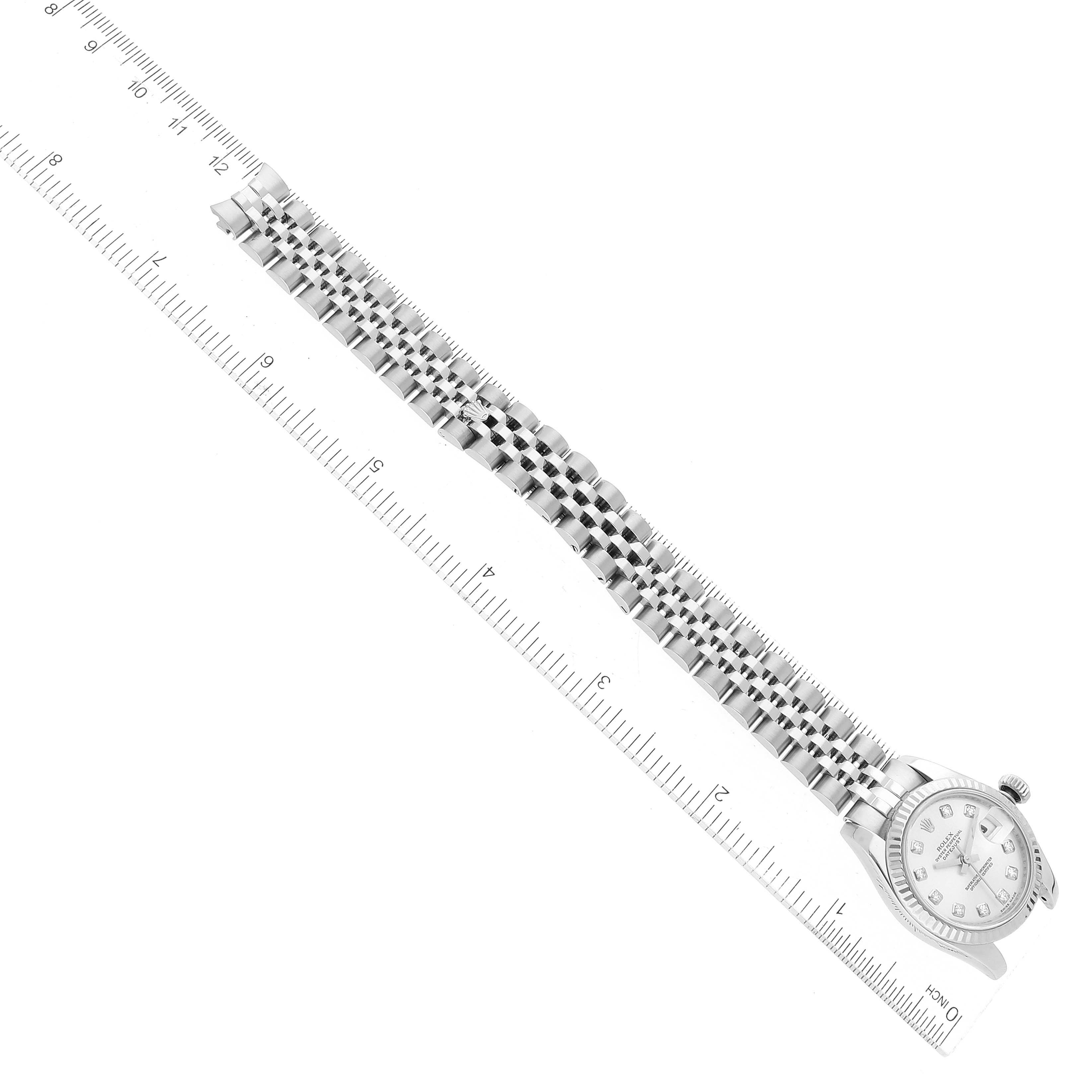 The image shows a Rolex Datejust 179174 Women's Stainless Steel Silver Dial 179174 Women's Stainless Steel Silver Dial watch placed at a diagonal angle, emphasizing the bracelet alongside a measurement ruler.