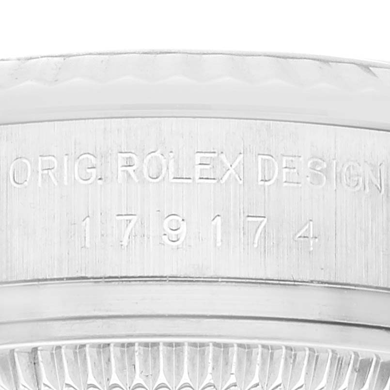 The image shows a close-up of the serial number and original design engraving on the case of the Rolex Datejust 179174 Women's Stainless Steel Silver Dial 179174 Women's Stainless Steel Silver Dial watch.