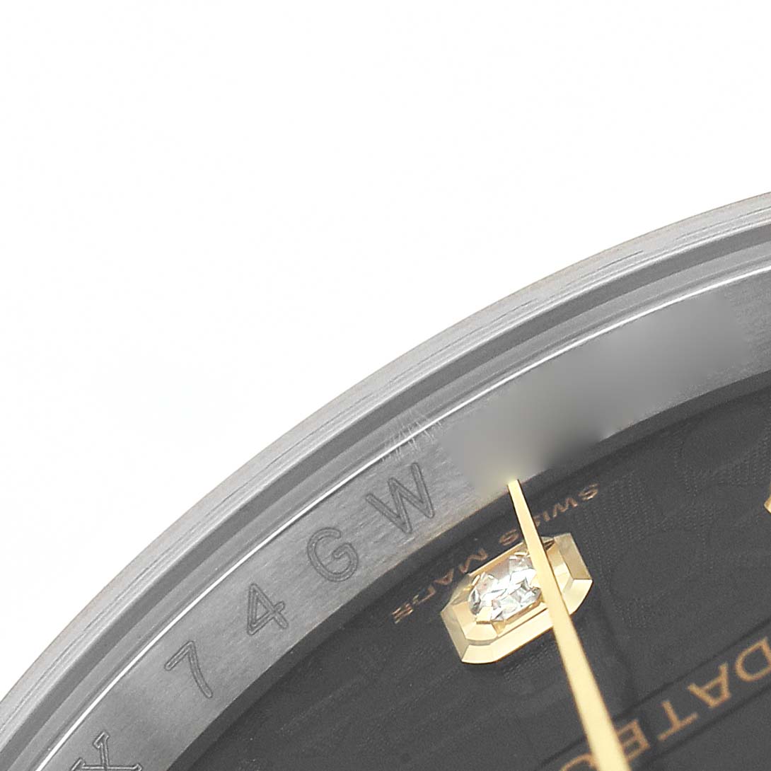 The image shows a close-up of the Rolex Datejust 116243 Men's Steel and Gold (two tone) Black Dial watch's dial edge, partial diamond marker, and inner bezel with model engraving.
