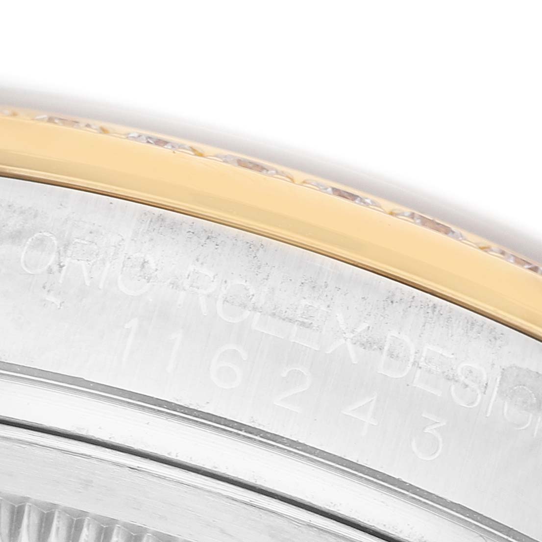 The image shows a close-up of the case side, bezel, and reference number on a Rolex Datejust 116243 Men's Steel and Gold (two tone) Black Dial watch.