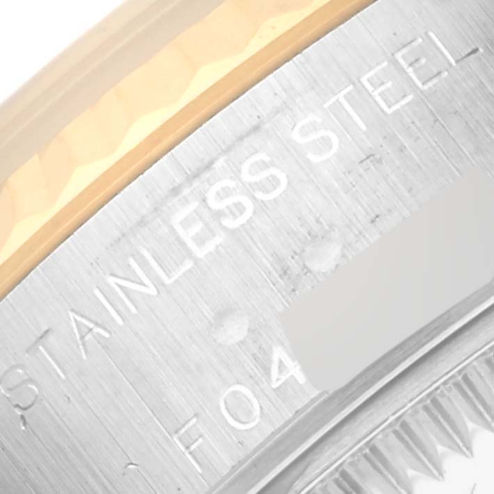 This close-up image shows the engraved stainless steel part of a Rolex Datejust 79173 Women's Stainless Steel Black Dial 79173 Women's Stainless Steel Black Dial watch.