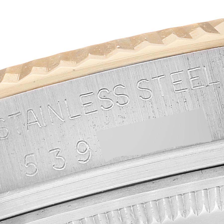 This close-up image shows the stainless steel casing and serial number of the Vintage Collection model watch by Rolex.