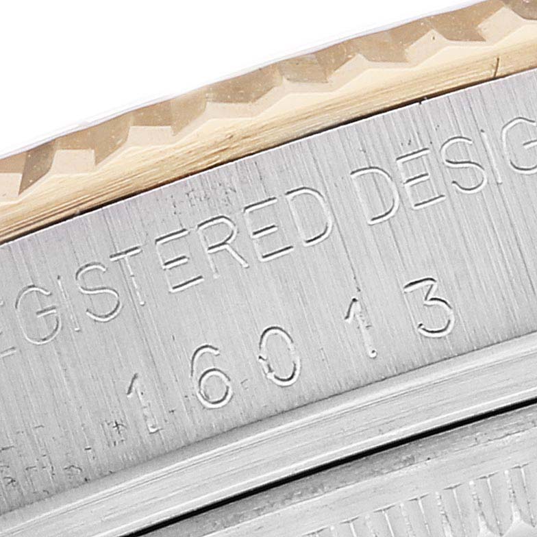 This close-up shows the engraved case back and part of the bezel of the Rolex Vintage Collection 16013 Men's Steel and Gold (two tone) White Dial 16013 Men's Steel and Gold (two tone) White Dial watch, model 16013.