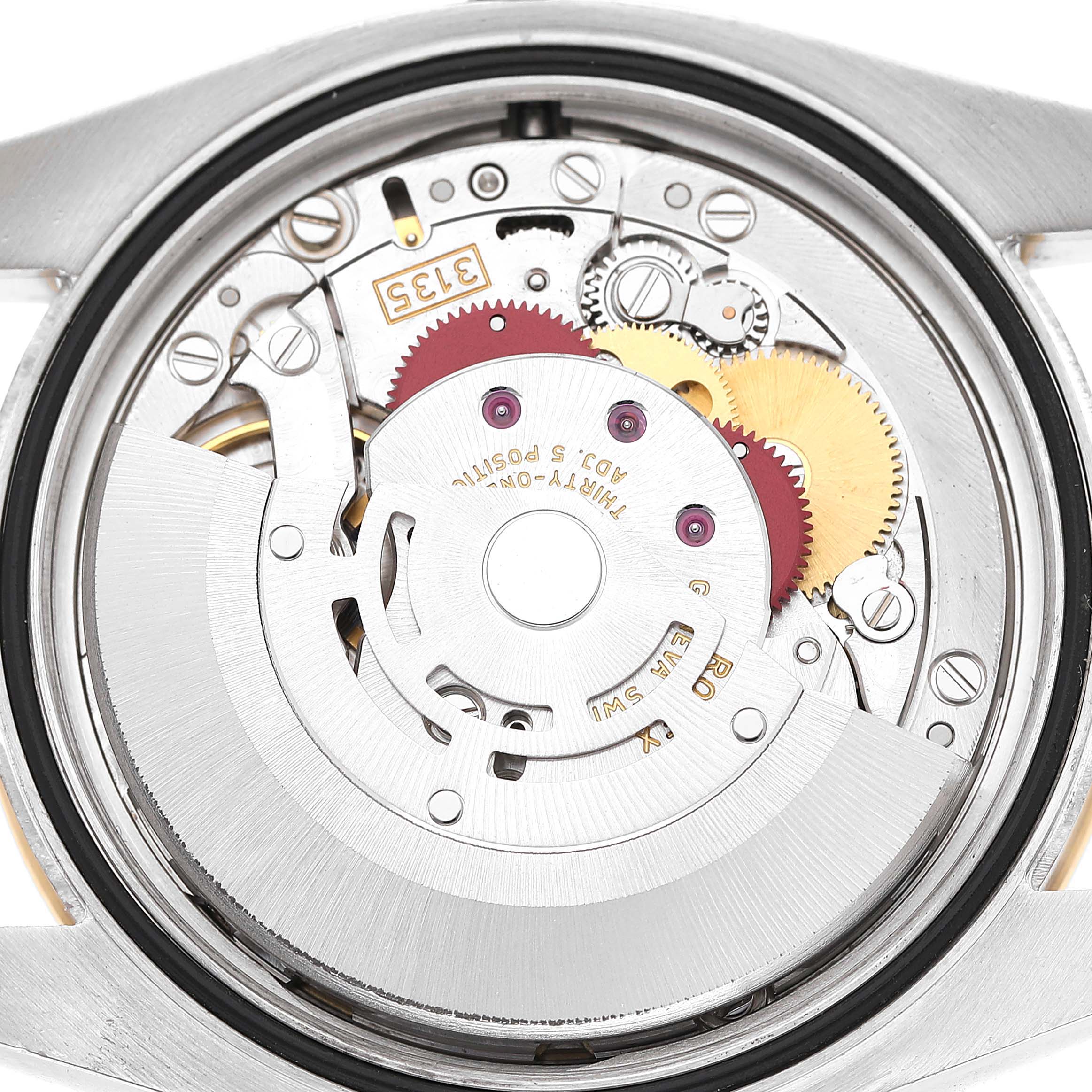 The image shows the automatic movement mechanism of a Rolex Datejust 116243 Men's Steel and Gold (two tone) Champagne Dial, viewed from the back.