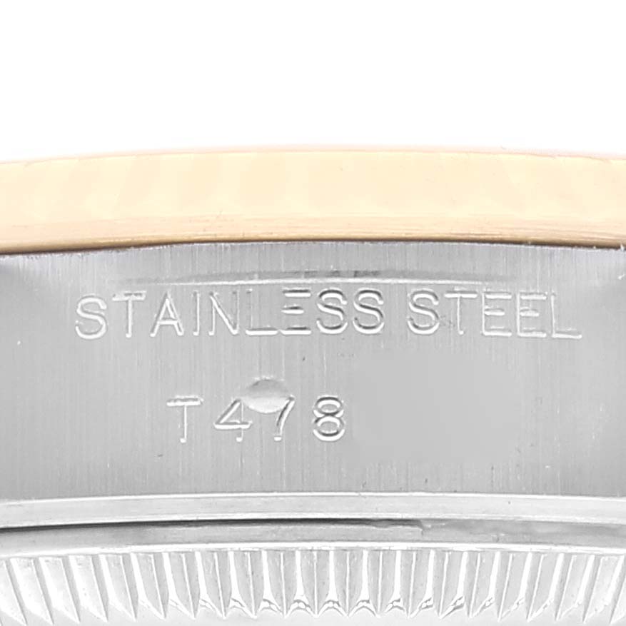 This close-up image shows the bezel and part of the case of a Rolex Datejust 69173 Women's Steel and Gold (two tone) Champagne Dial 69173 Women's Steel and Gold (two tone) Champagne Dial watch, with the engraving "STAINLESS STEEL T478."