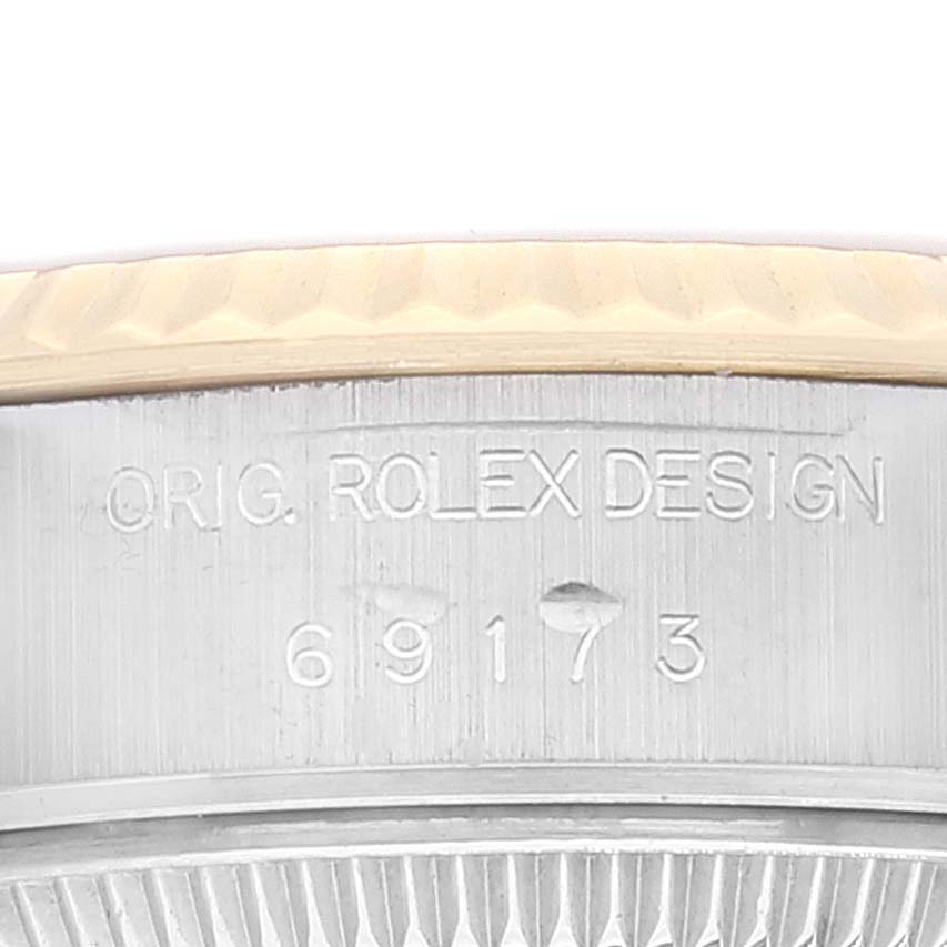The image shows a close-up view of the bezel and engraved serial number of a Rolex Datejust 69173 Women's Steel and Gold (two tone) Champagne Dial 69173 Women's Steel and Gold (two tone) Champagne Dial watch.
