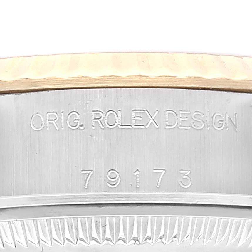 The image shows a close-up of the engraved bezel and serial number of a Rolex Datejust 79173 Women's Steel and Gold (two tone) Champagne Dial 79173 Women's Steel and Gold (two tone) Champagne Dial watch.