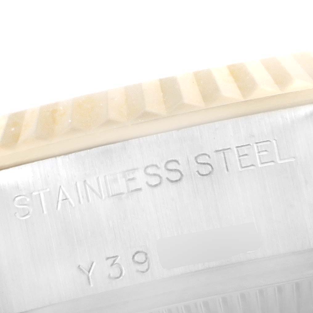 The image shows a close-up of the fluted bezel and stainless steel case with engravings on a Rolex Datejust 79173 Women's Steel and Gold (two tone) White Dial 79173 Women's Steel and Gold (two tone) White Dial watch.