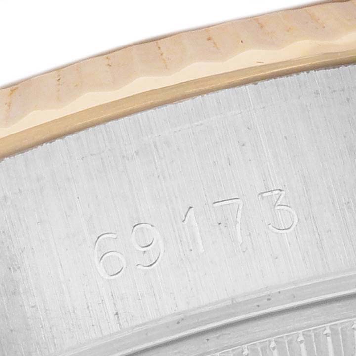 The image shows a close-up of the Rolex Datejust 69173 Women's Steel and Gold (two tone) White Dial 69173 Women's Steel and Gold (two tone) White Dial model's case with the model number 69173 engraved.