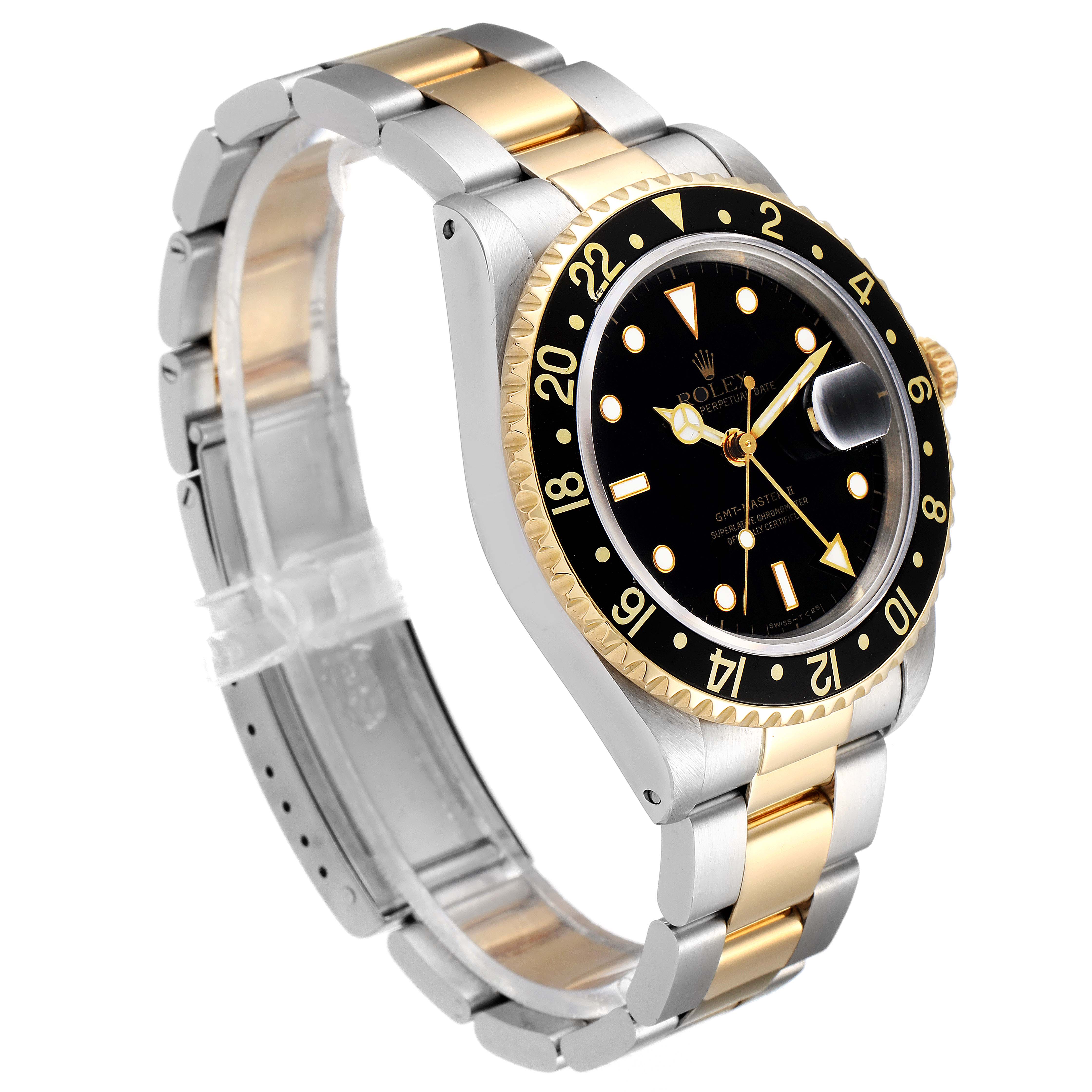 The watch, shown at an angle, reveals the face, bezel, crown, and part of the bracelet of the Rolex GMT-Master 16713 Men's Steel and Gold (two tone) Black Dial 16713 Men's Steel and Gold (two tone) Black Dial model.