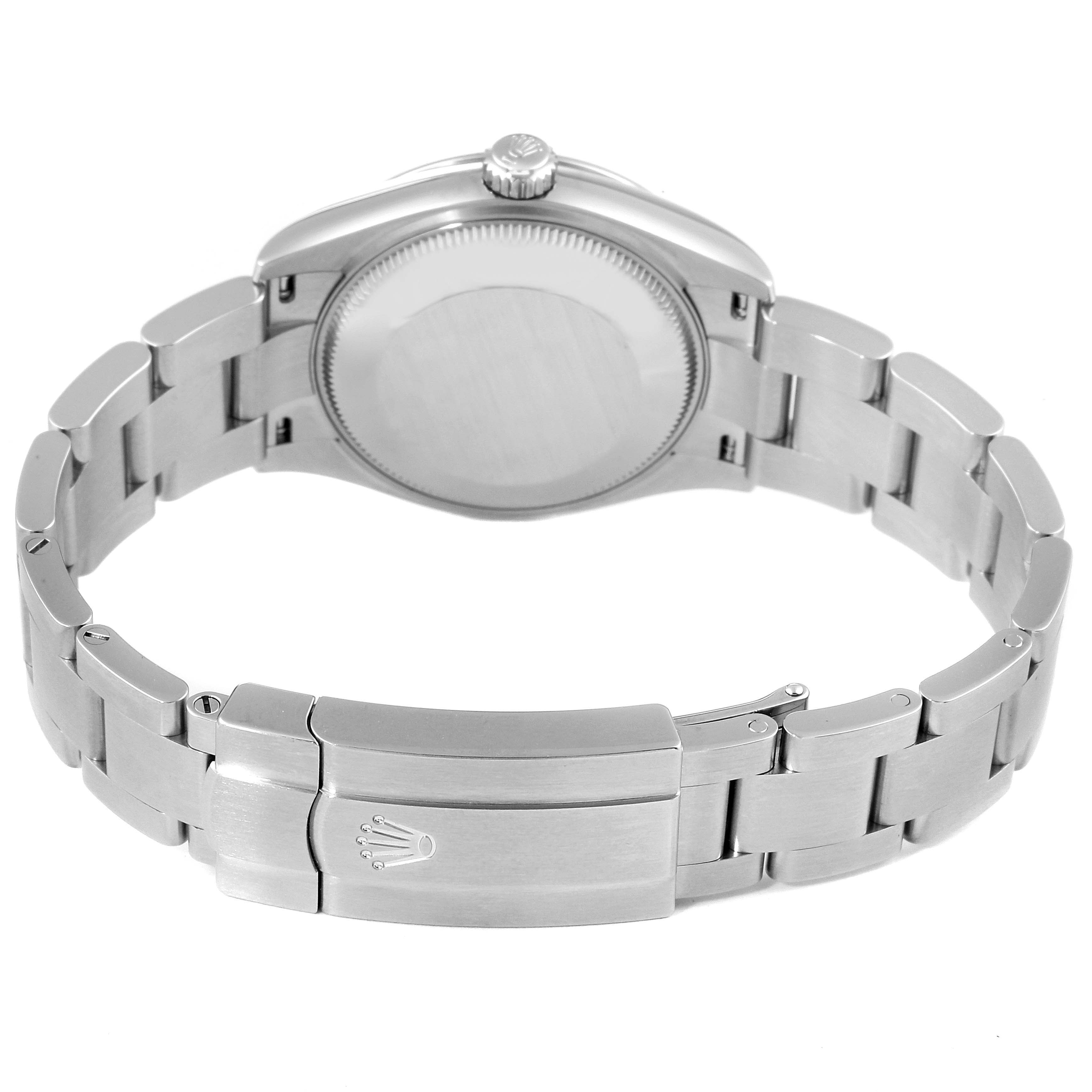 This image shows the back case and bracelet clasp with the crown logo of a Mid-Size Rolex watch from a rear angle.