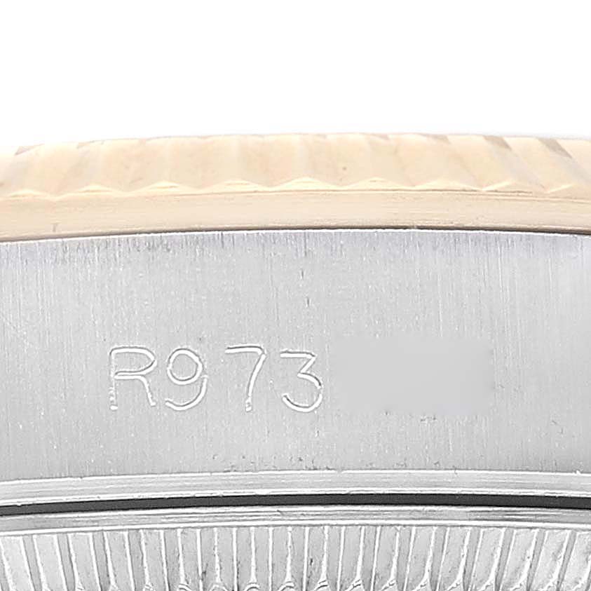 This image shows a close-up of the bezel and serial number engraving on a Rolex Oyster Perpetual 67193 Women's Steel and Gold (two tone) Champagne Dial 67193 Women's Steel and Gold (two tone) Champagne Dial watch.