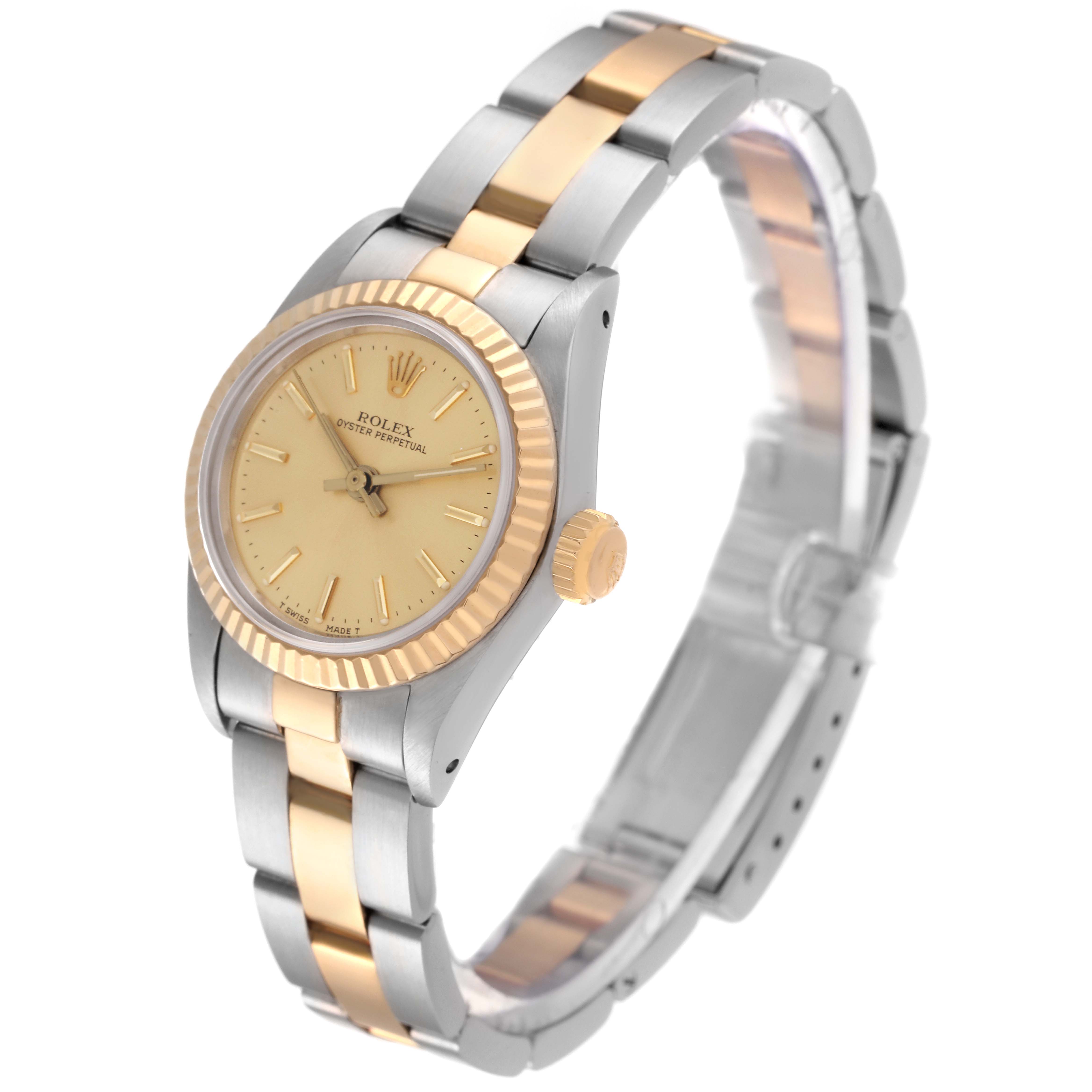 This image shows a side angle of a Rolex Oyster Perpetual 67193 Women's Steel and Gold (two tone) Champagne Dial 67193 Women's Steel and Gold (two tone) Champagne Dial watch, highlighting its two-tone bracelet and fluted bezel.