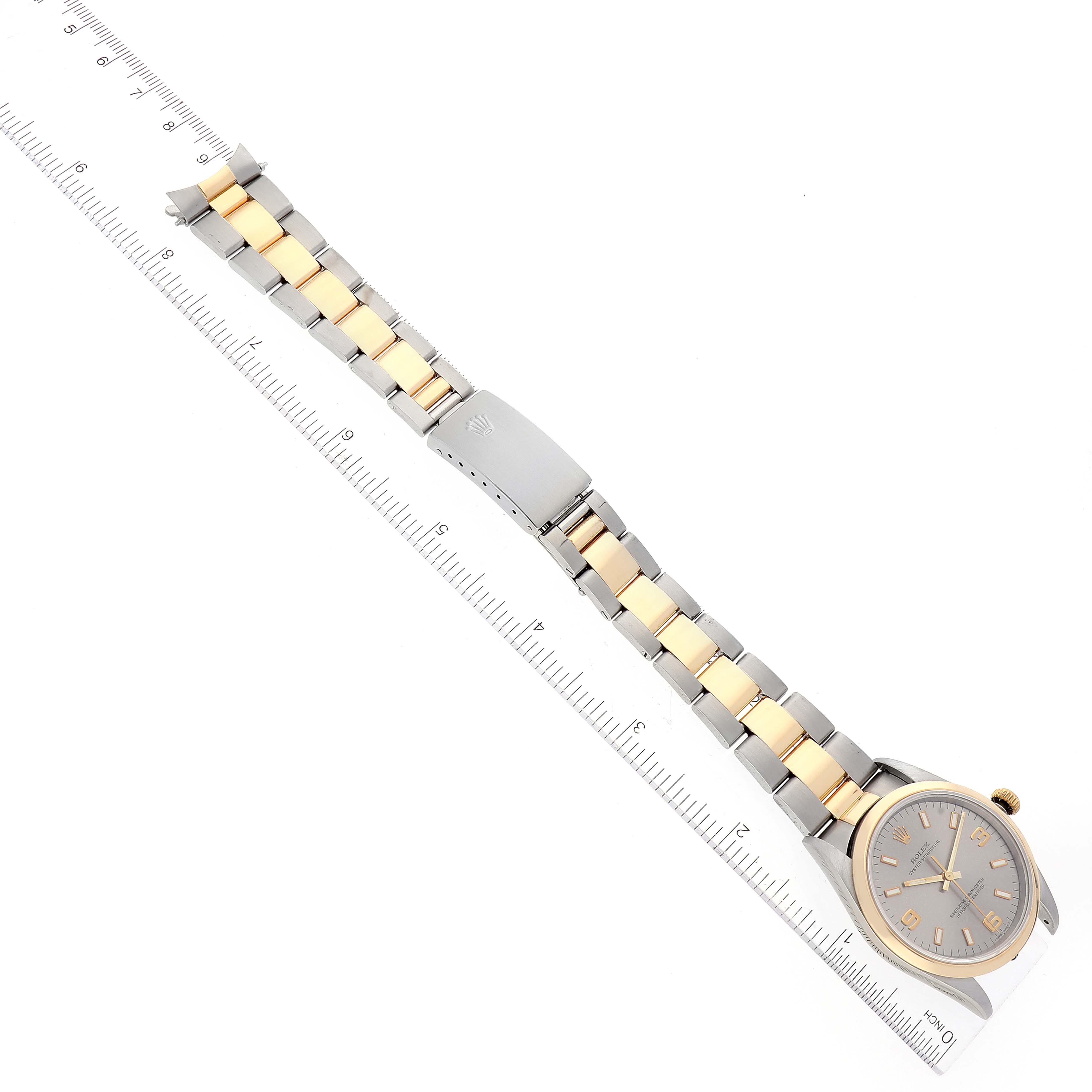The image shows a Rolex Oyster Perpetual 14203 Men's Steel and Gold (two tone) Grey Dial 14203 Men's Steel and Gold (two tone) Grey Dial watch laid flat with its bracelet extended and positioned along a ruler for measurement.
