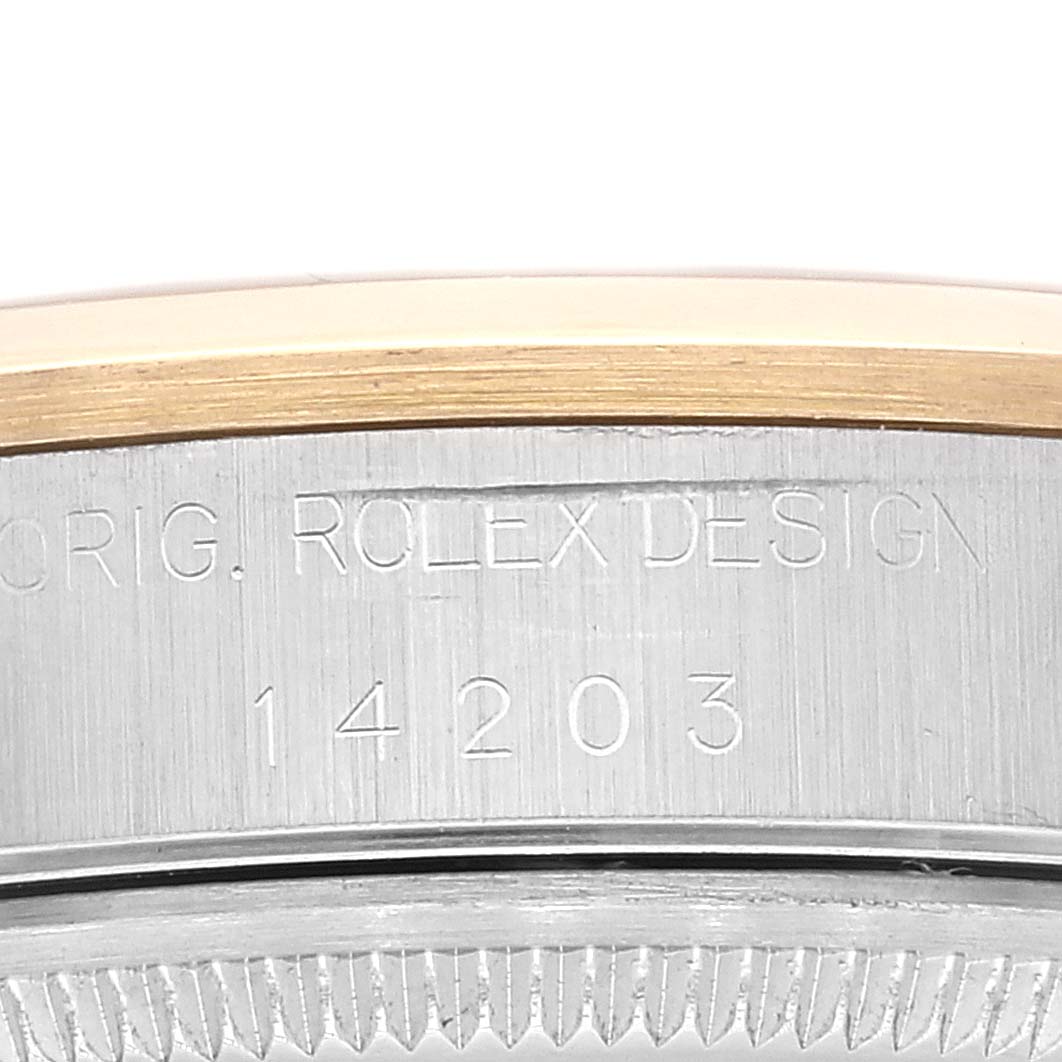 This close-up image shows the side of the bezel and the engraved model number "14203" of the Rolex Oyster Perpetual 14203 Men's Steel and Gold (two tone) Grey Dial 14203 Men's Steel and Gold (two tone) Grey Dial watch.