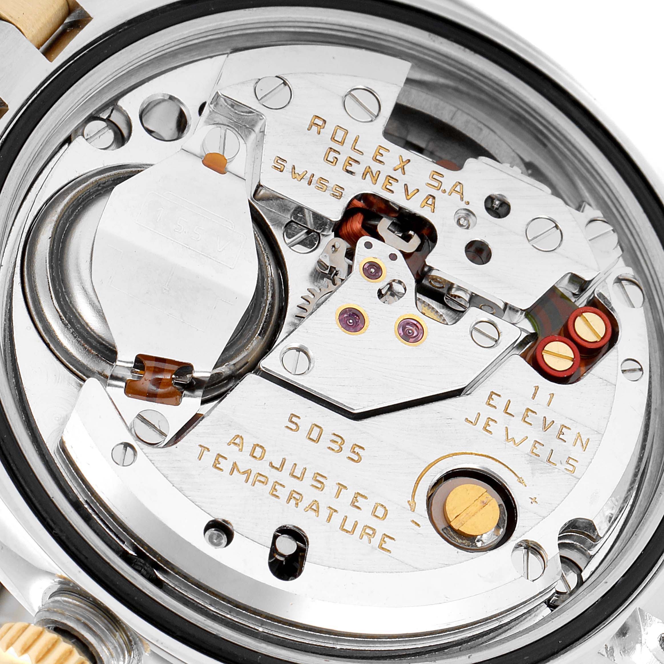 This image shows a close-up view of the movement of a Rolex Oysterquartz 17013 Men's Steel and Gold (two tone) Champagne Dial 17013 Men's Steel and Gold (two tone) Champagne Dial watch, highlighting its internal components and engravings.