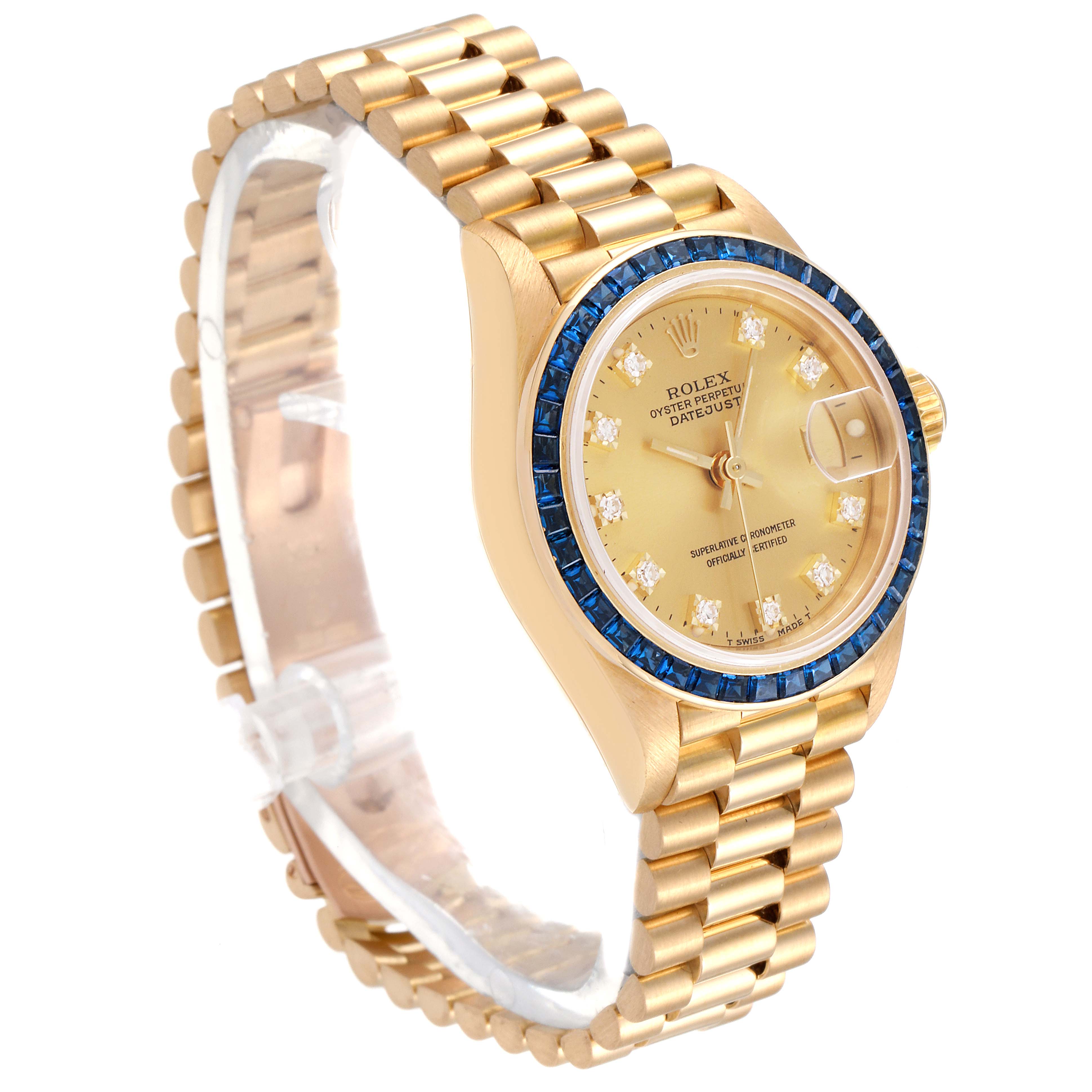 The image shows a Rolex President 69118 Women's Yellow Gold Champagne Dial 69118 Women's Yellow Gold Champagne Dial watch, angled to display the gold band, blue bezel, and detailed golden face with date and diamond markers.