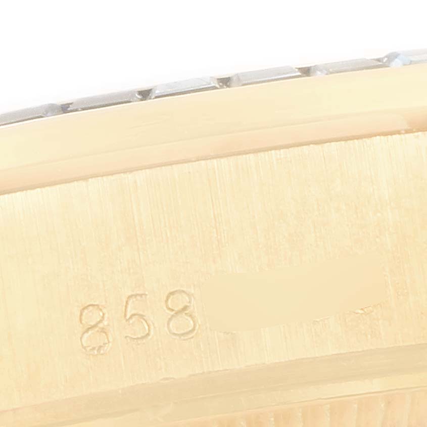The image shows a close-up of the serial number engravings on the side case of a Rolex President 69118 Women's Yellow Gold Champagne Dial 69118 Women's Yellow Gold Champagne Dial watch.