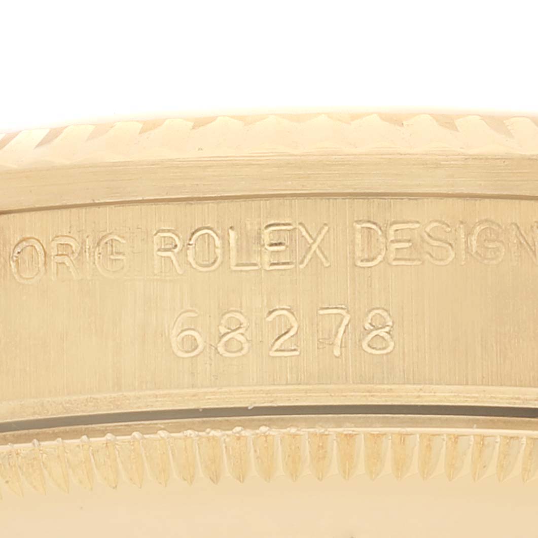 This image shows a close-up of the case back edge of a Rolex President 68278 Women
s Yellow Gold Champagne Dial 68278 Women
s Yellow Gold Champagne Dial model with the text "ORG ROLEX DESIGN 68278" engraved.