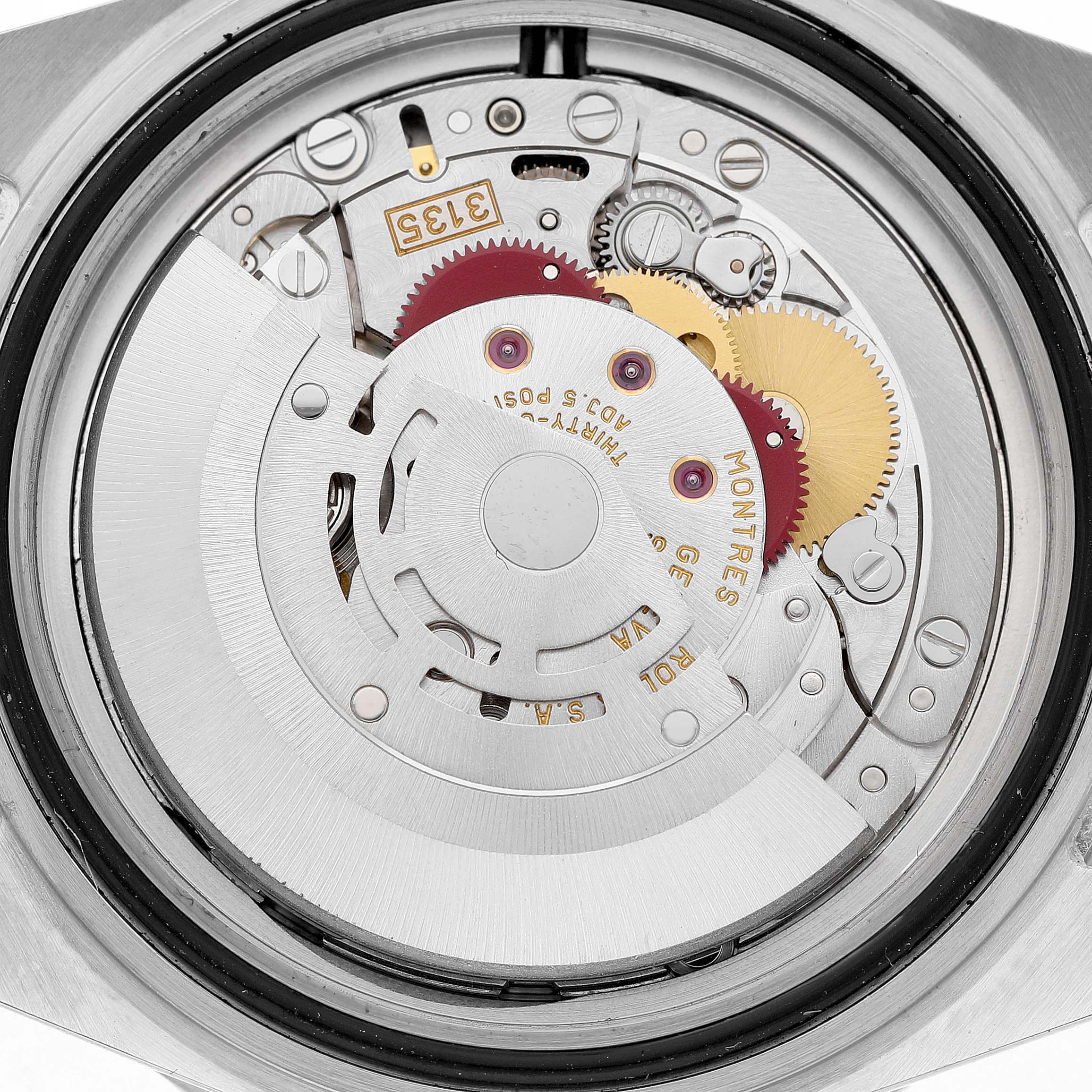 The image shows a detailed view of the Rolex Submariner 16610 Men's Stainless Steel Black Dial's movement, featuring gears and the rotor.