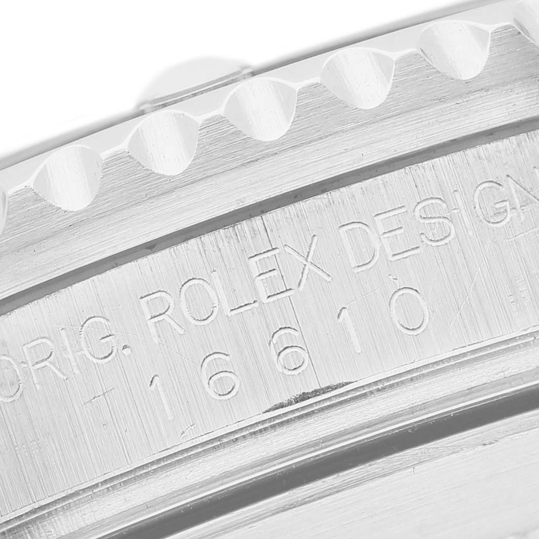 This close-up image shows the engraved side of the bezel and case of a Rolex Submariner 16610 Men's Stainless Steel Black Dial watch.