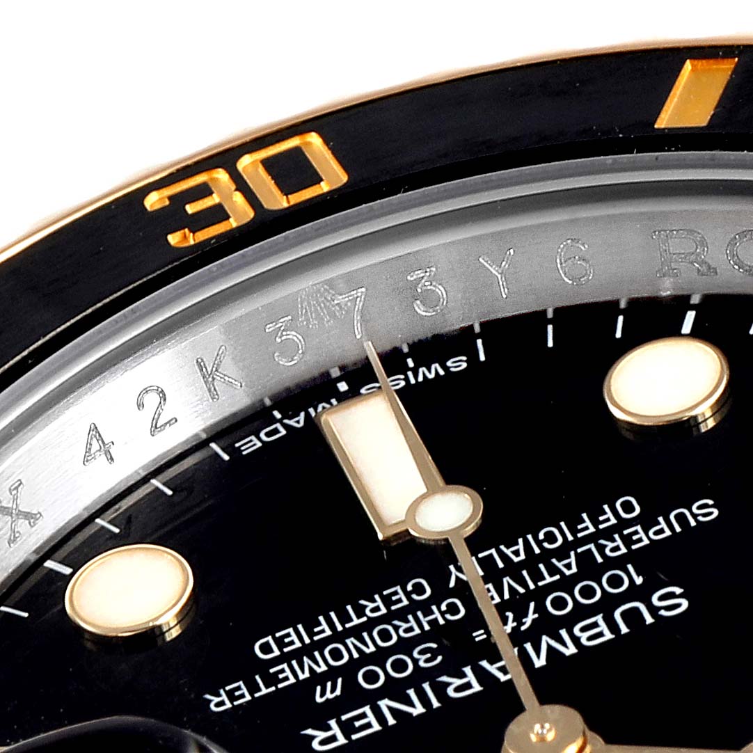 This close-up angle shows the dial, hour markers, minute hand, and part of the bezel of the Rolex Submariner 116613 Men's Steel and Gold (two tone) Black Dial 116613 Men's Steel and Gold (two tone) Black Dial watch.