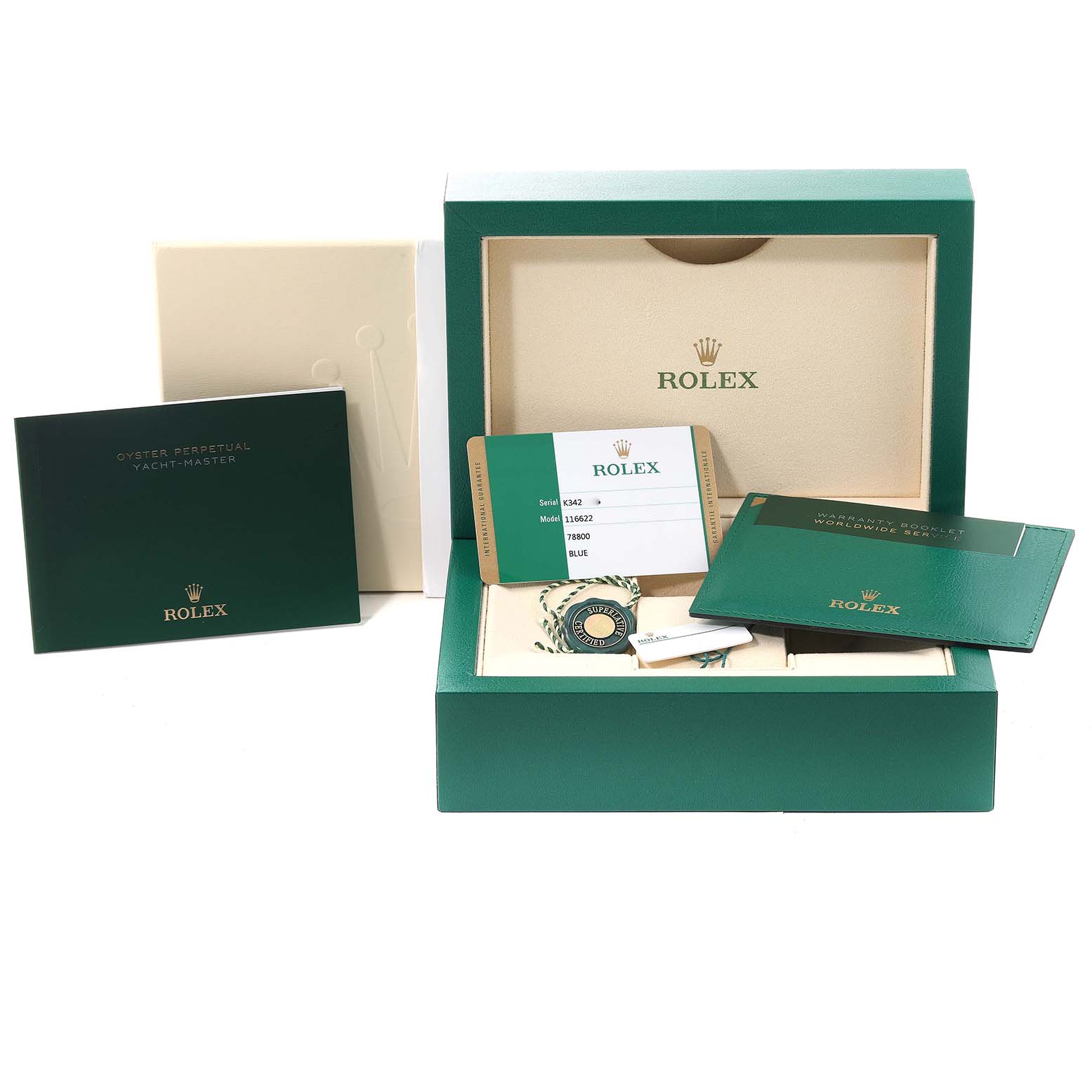 The image shows packaging and paperwork of a Rolex Yacht-Master 116622 Men
s Stainless Steel Blue Dial 116622 Men
s Stainless Steel Blue Dial watch, including the box, warranty card, and booklets.