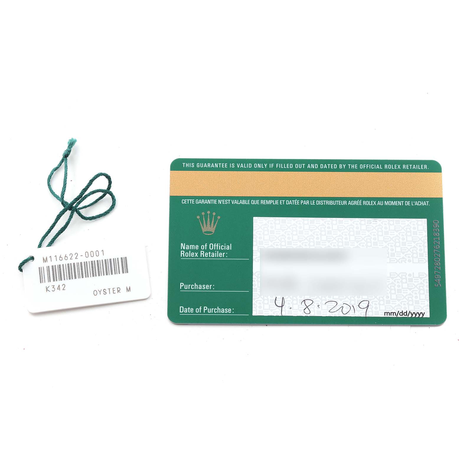 The image shows a green warranty card and a tag with a serial number for a Rolex Yacht-Master 116622 Men
s Stainless Steel Blue Dial 116622 Men
s Stainless Steel Blue Dial model.