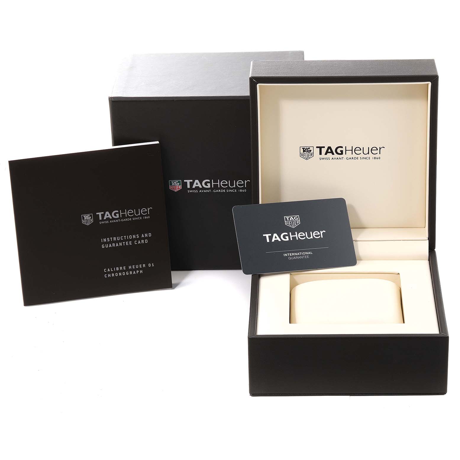 The image shows the packaging and accessories for the Carrera model by Tag Heuer, including the box, warranty card, and instruction manual.