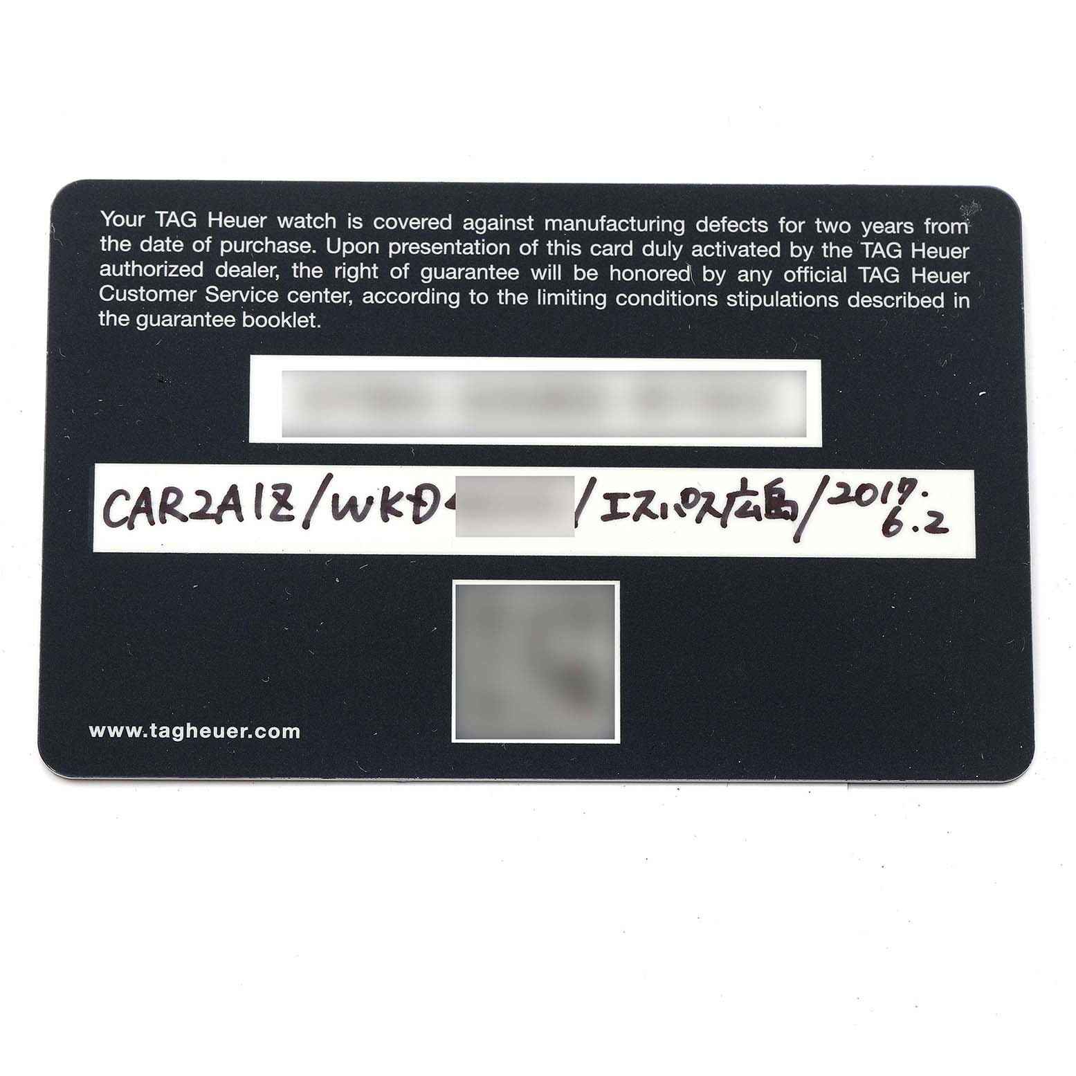 The image shows a warranty card for a Tag Heuer Carrera CAR2A1Z Men
s Stainless Steel Black Dial CAR2A1Z Men
s Stainless Steel Black Dial model watch, taken from a top-down angle.