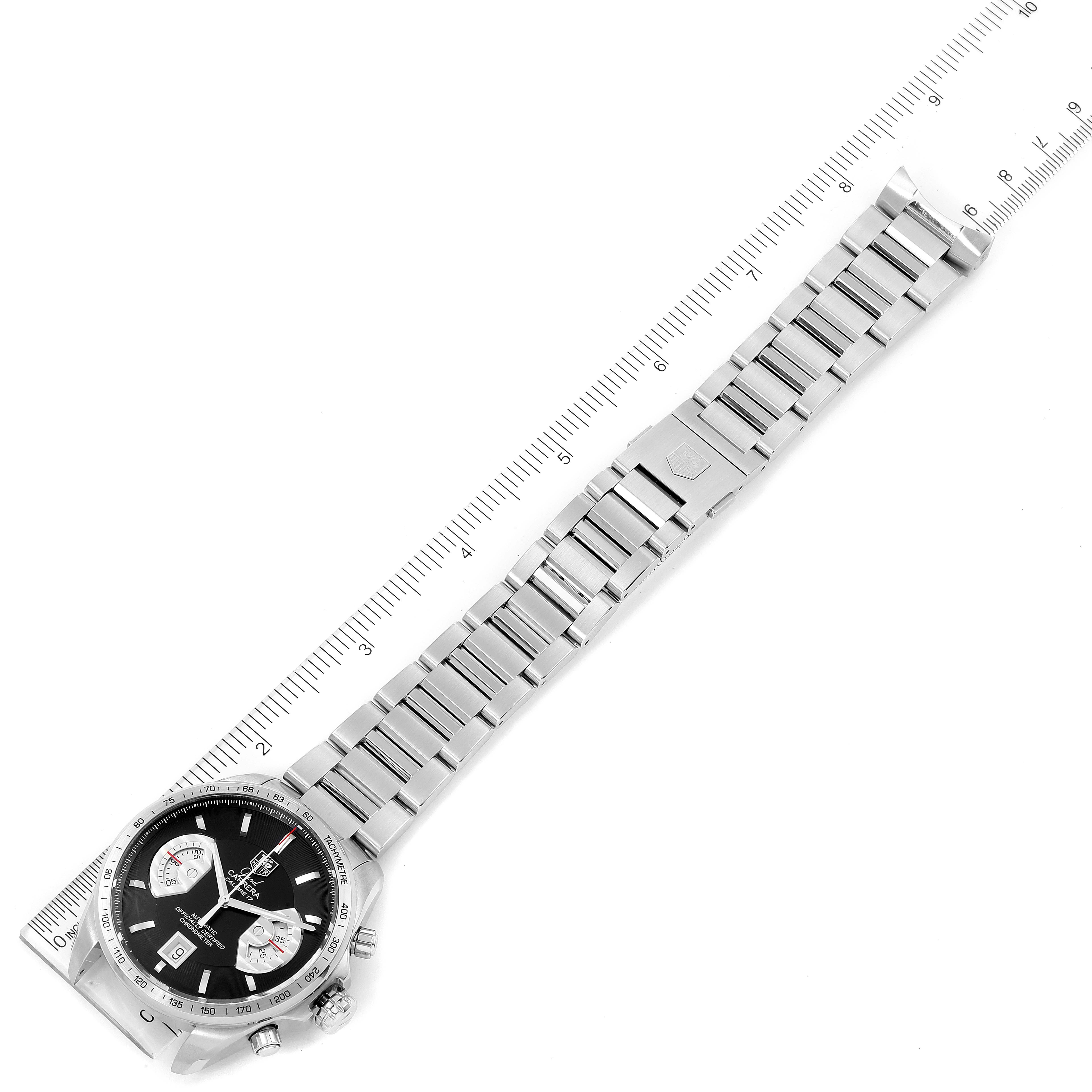 The image shows a Tag Heuer Carrera CAV511A Men
s Stainless Steel Black Dial CAV511A Men
s Stainless Steel Black Dial watch and its stainless steel band laid flat next to a ruler for measurement.