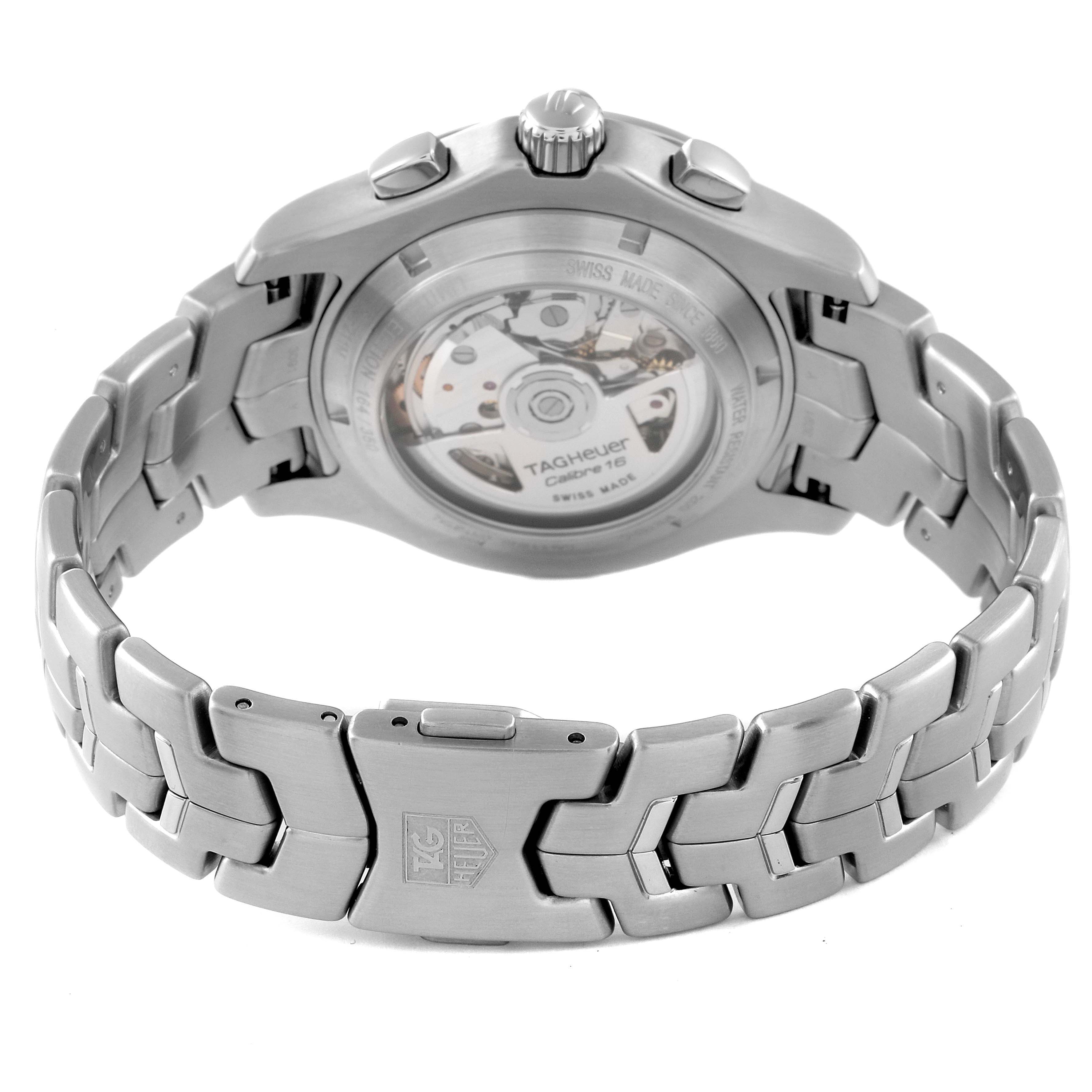The image shows the back view of a Tag Heuer Link model watch, focusing on its movement and stainless steel bracelet.