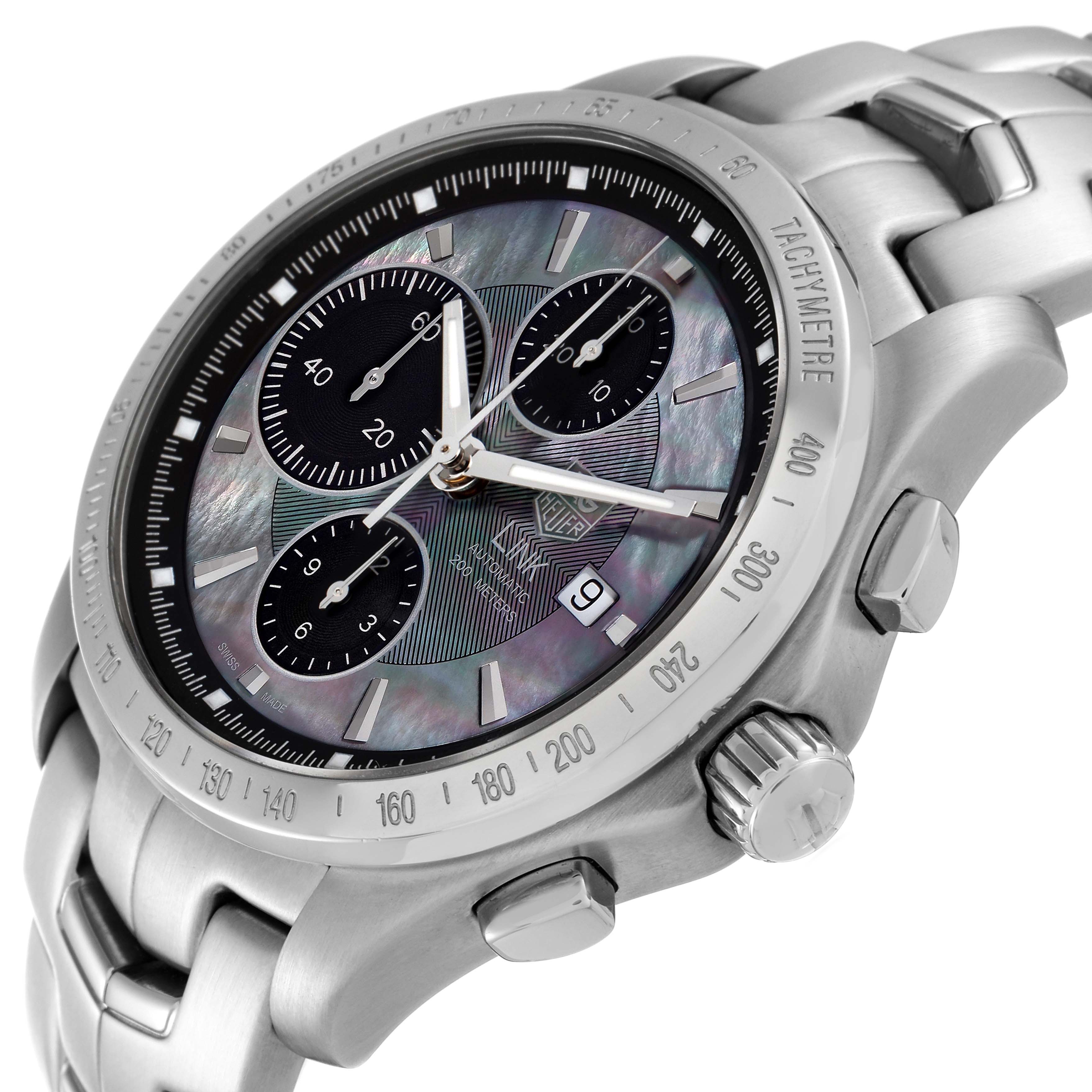 The image shows a close-up angle of the Tag Heuer Link watch, highlighting its dial, bezel, crown, and chronograph pushers.