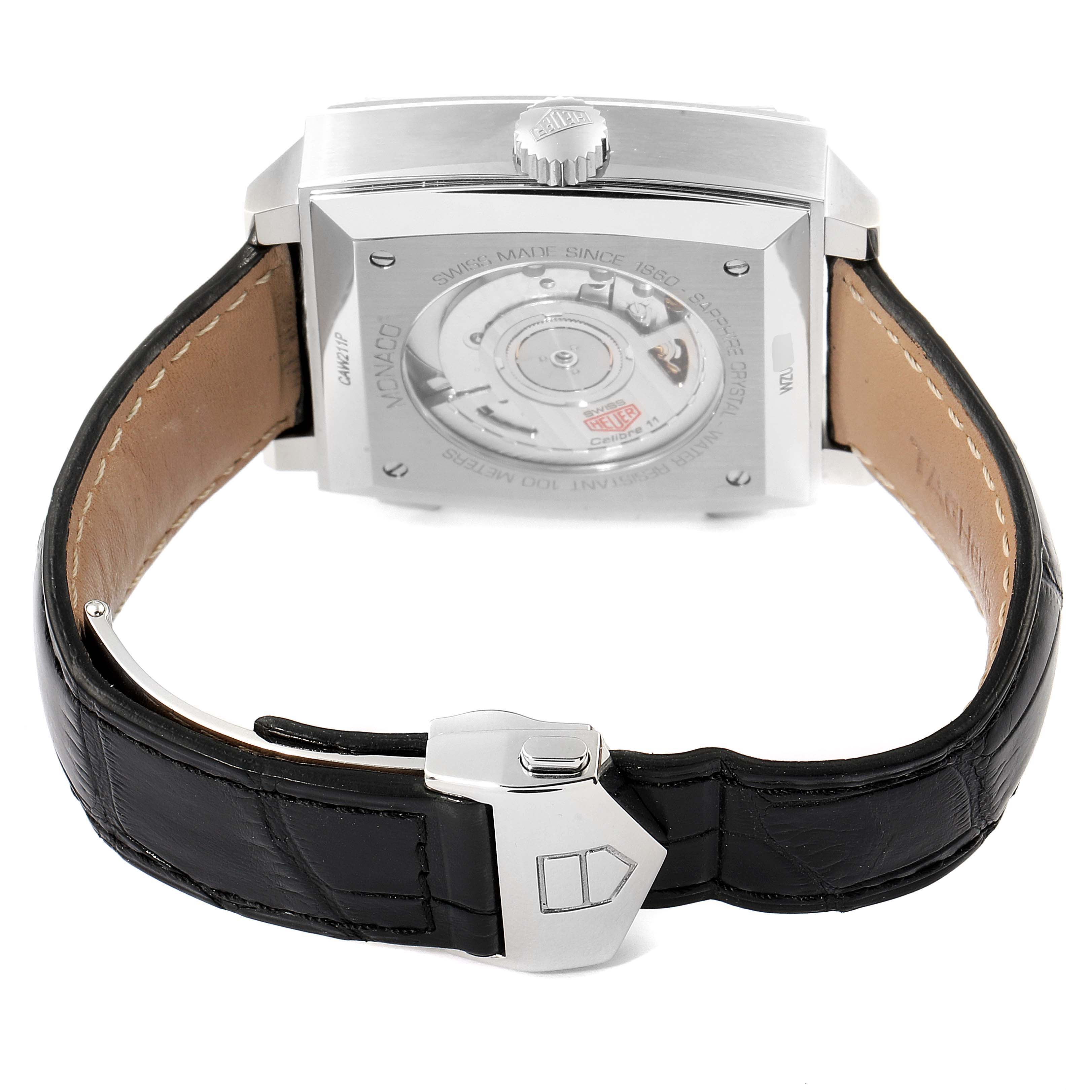 The image shows the back case and black leather strap of a Tag Heuer Monaco CAW211P Men's Stainless Steel Blue Dial CAW211P Men's Stainless Steel Blue Dial watch, featuring its clasp and exposed movement.