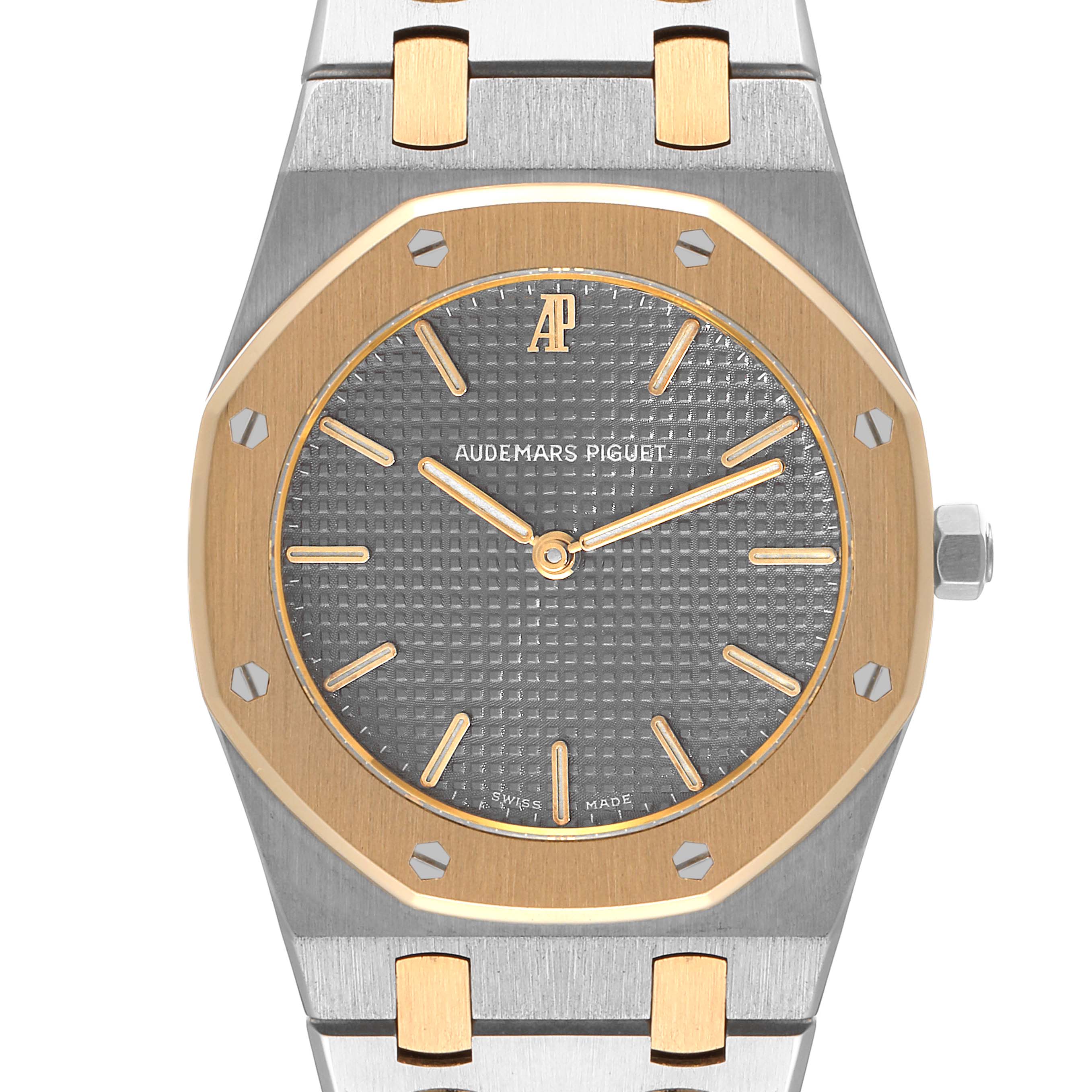 The image shows a frontal view of the Audemars Piguet Royal Oak 56303SA Men's Steel and Gold (two tone) Grey Dial 56303SA Men's Steel and Gold (two tone) Grey Dial watch, highlighting its dial, bezel, and part of its bracelet.