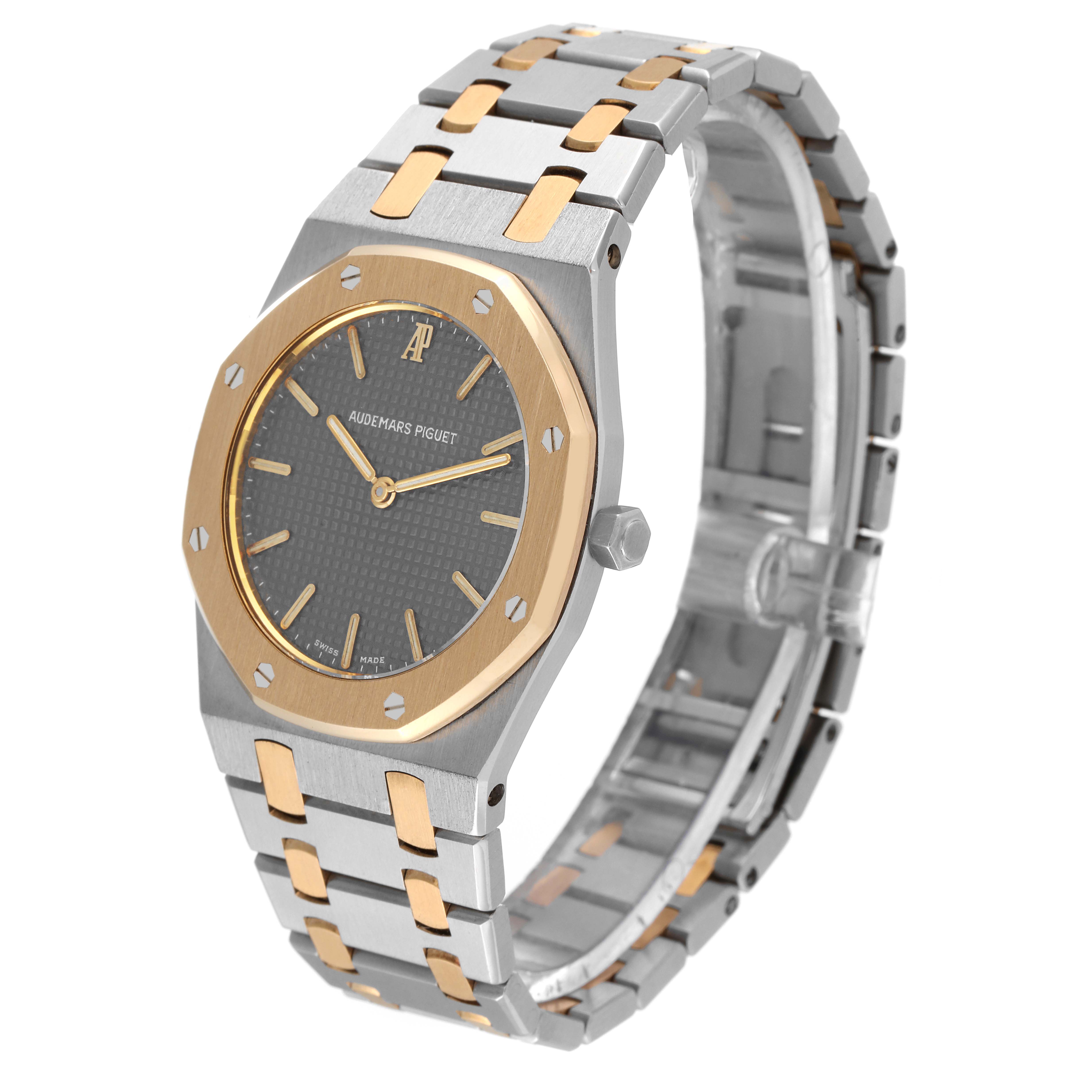 Audemars Piguet Royal Oak 56303SA Men's Steel and Gold (two tone) Grey Dial 56303SA Men's Steel and Gold (two tone) Grey Dial watch is shown at a 3/4 angle, displaying the face, bezel, crown, and part of the bracelet.