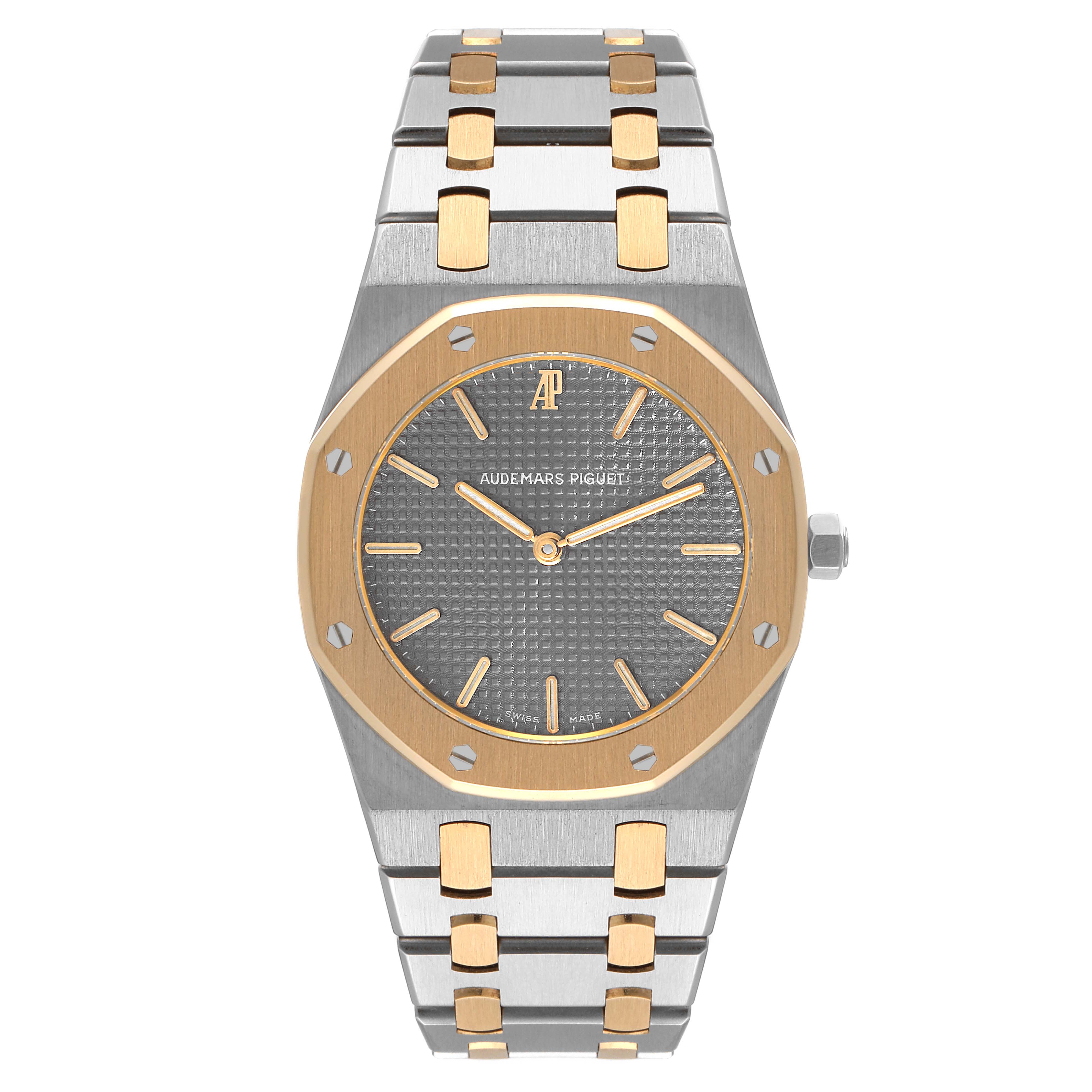 The image shows a frontal view of the Audemars Piguet Royal Oak 56303SA Men's Steel and Gold (two tone) Grey Dial 56303SA Men's Steel and Gold (two tone) Grey Dial watch, highlighting its dial, bezel, and bracelet.