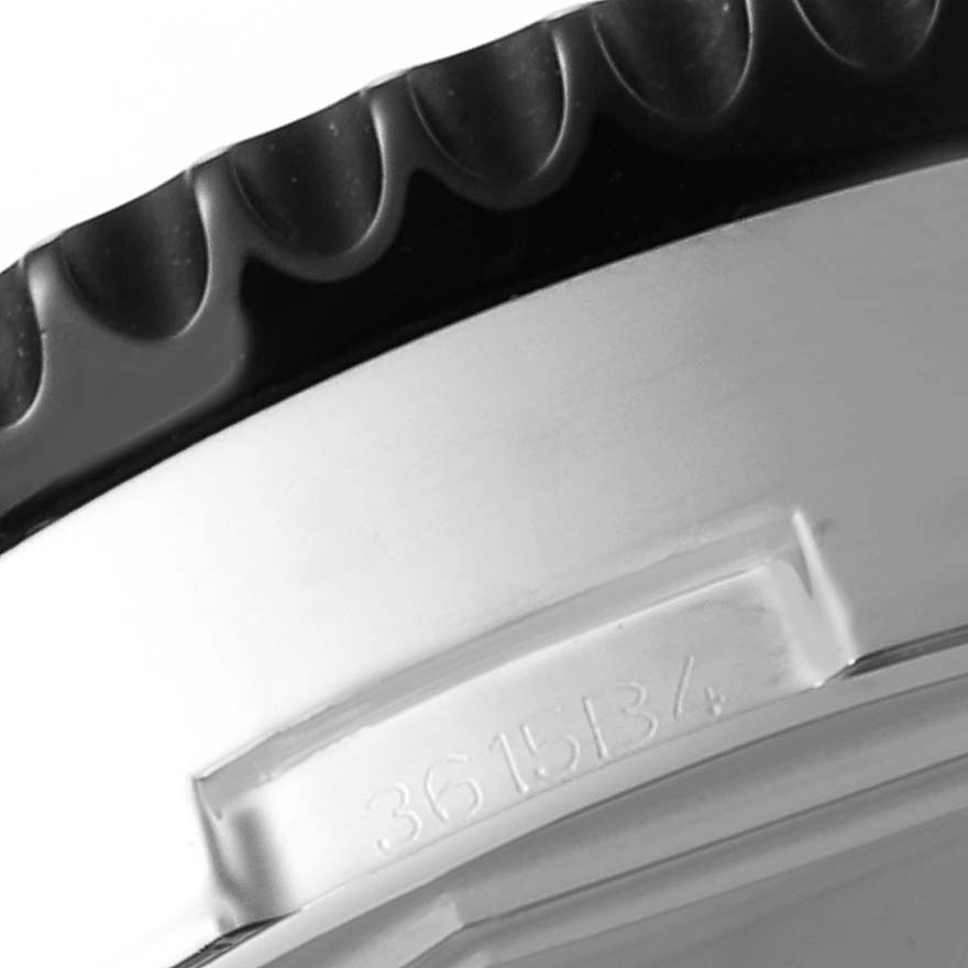The image shows a close-up of the bezel and part of the casing of a Breitling Chronoliner Y2431012/BE10 Men's Stainless Steel Black Dial Y2431012/BE10 Men's Stainless Steel Black Dial watch.