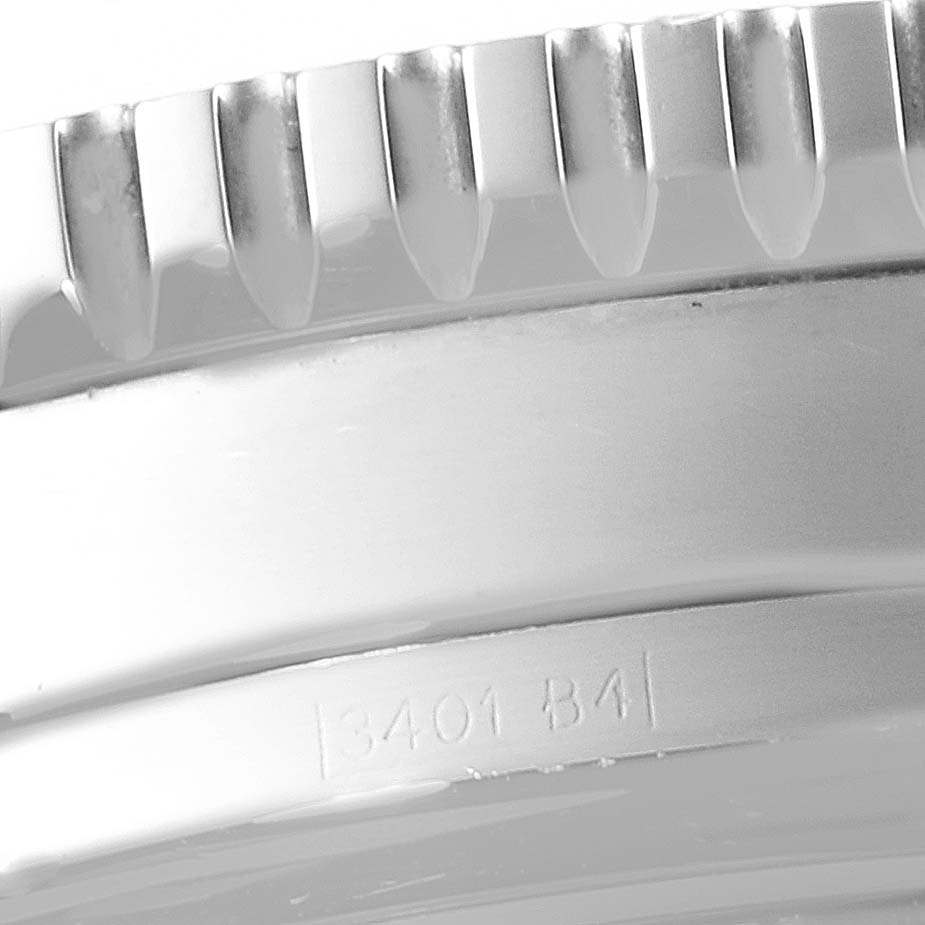 Close-up of the bezel teeth and part of the casing on a Breitling Navitimer A19340 Men's Stainless Steel Silver Dial A19340 Men's Stainless Steel Silver Dial watch, showing the serial number 3401 B4.